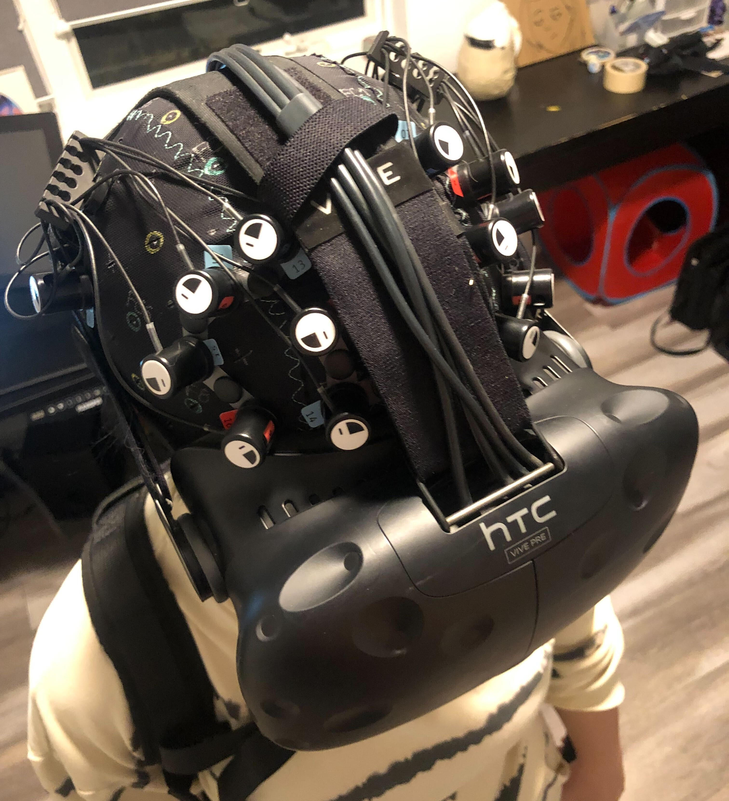 NIRx fNIRS cap recorded concurrently with an HTC Vive headset — fNIRS and VR on one participant, at the same time.