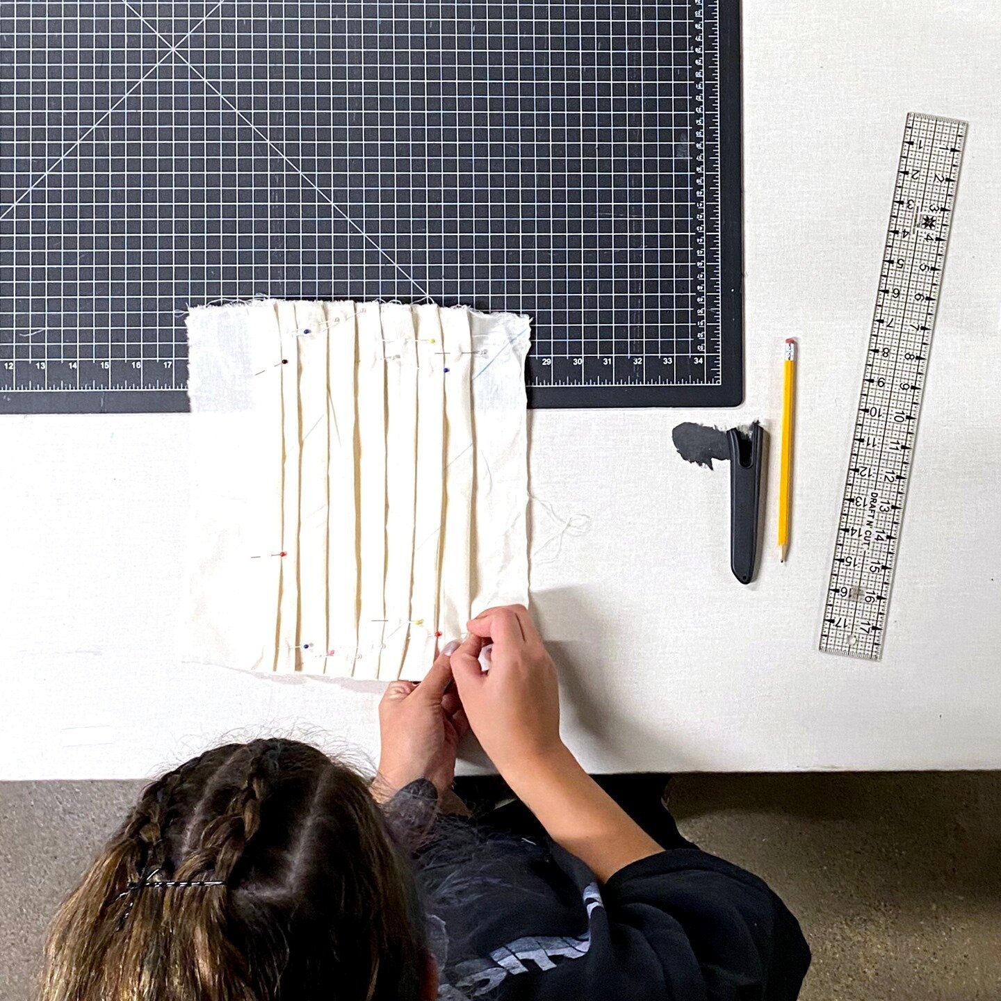 Knife Pleats like these are created by carefully doubling fabric back on itself and securing it in place.⁠
Materials studies student @p90lex is measuring precisely each fold and fixes it with a pin before sewing. ⁠
⁠
Do you prefer pleating by hand or