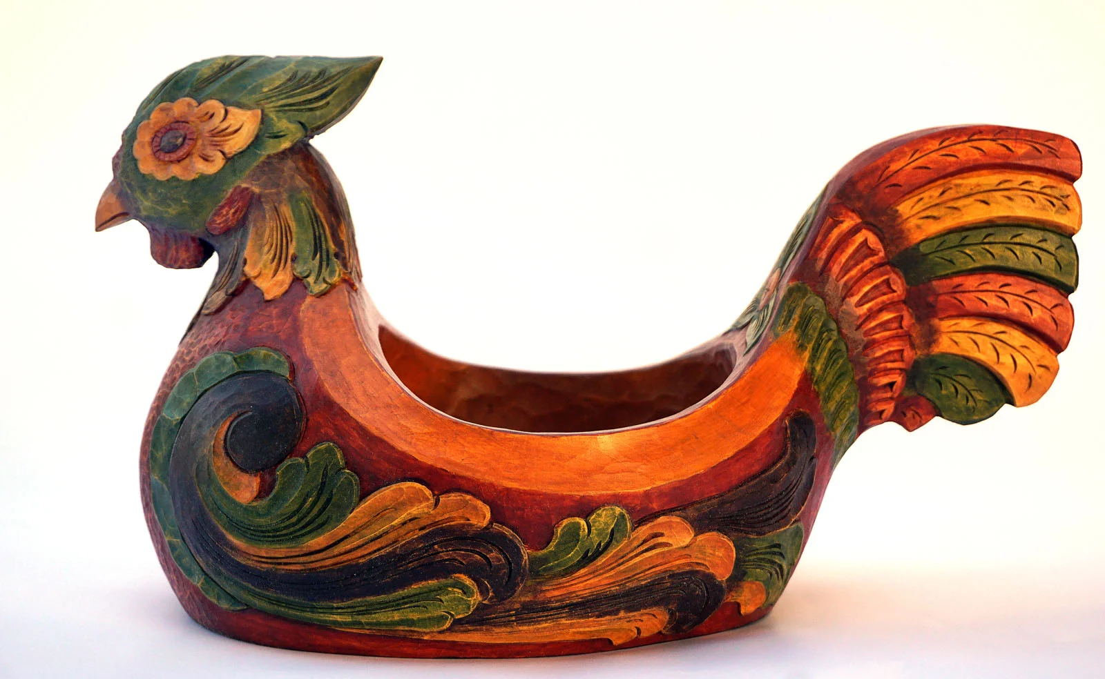 Showy Bird Ale Bowl by Phillip Odden, 2018 13 1/2" Long, 8" wide and 7 1/4" high. Basswood with Acrylic paint. Price: $750 The rooster image is quite common in traditional Nordic culture and offers many diverse meanings. Over the years I have created a number of rooster and hen chicken ale bowl forms. This is my latest original creation in that continued series. This one is fairly large and builds on what I have done before in part with influences from recent inspiration from travels to Scandinavia. 