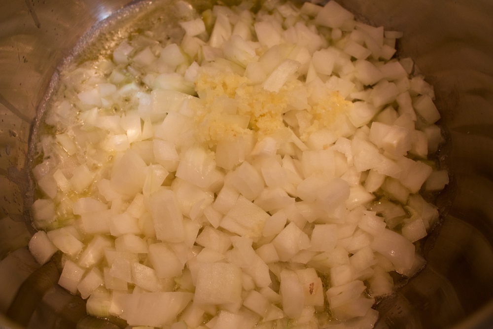 5. Add onions and garlic to the pot and sautee until soft