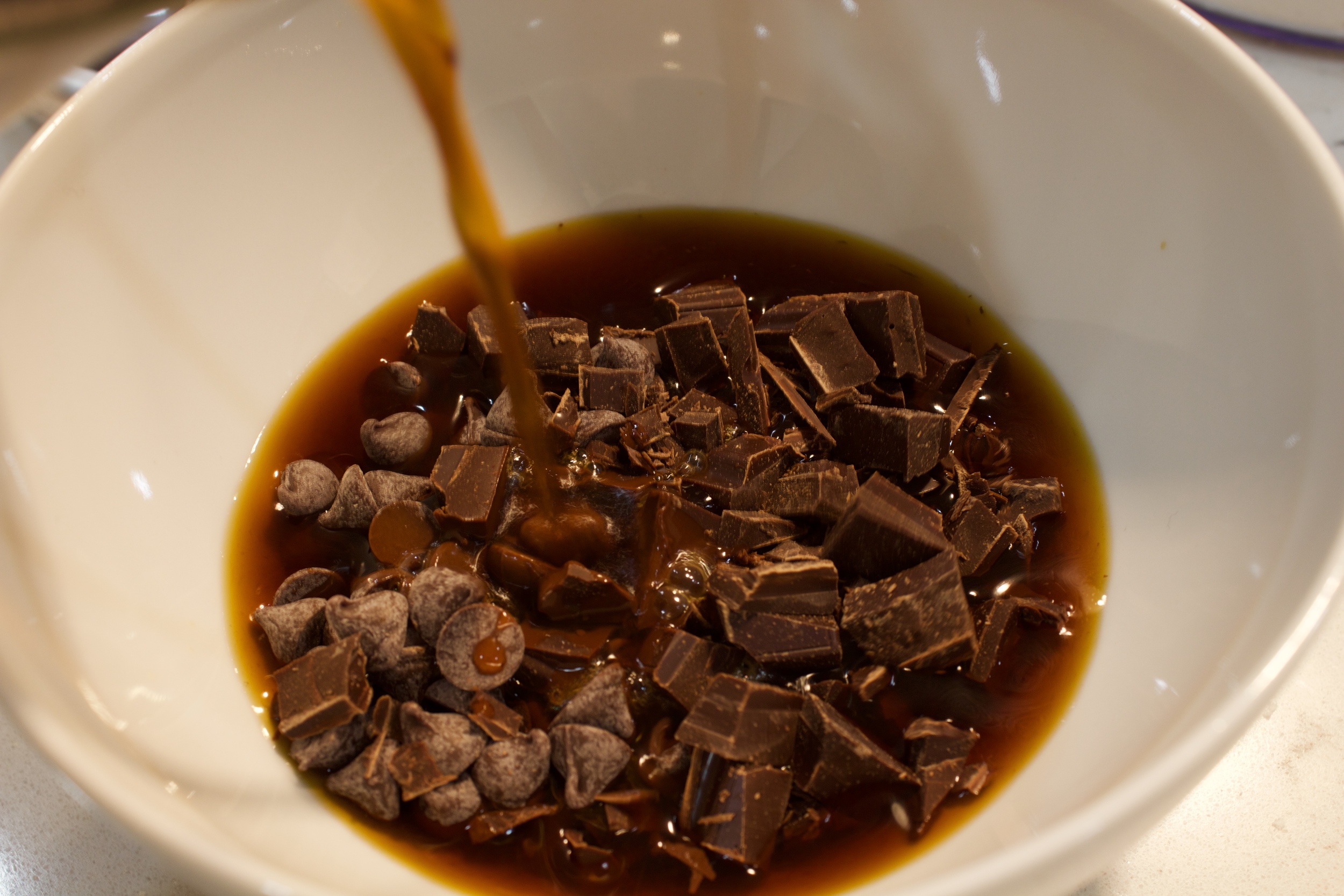  Pour the hot coffee into the bowl of chocolate and allow it to sit for about two minutes 