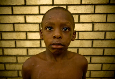 Boy in Front of a Brick Wall