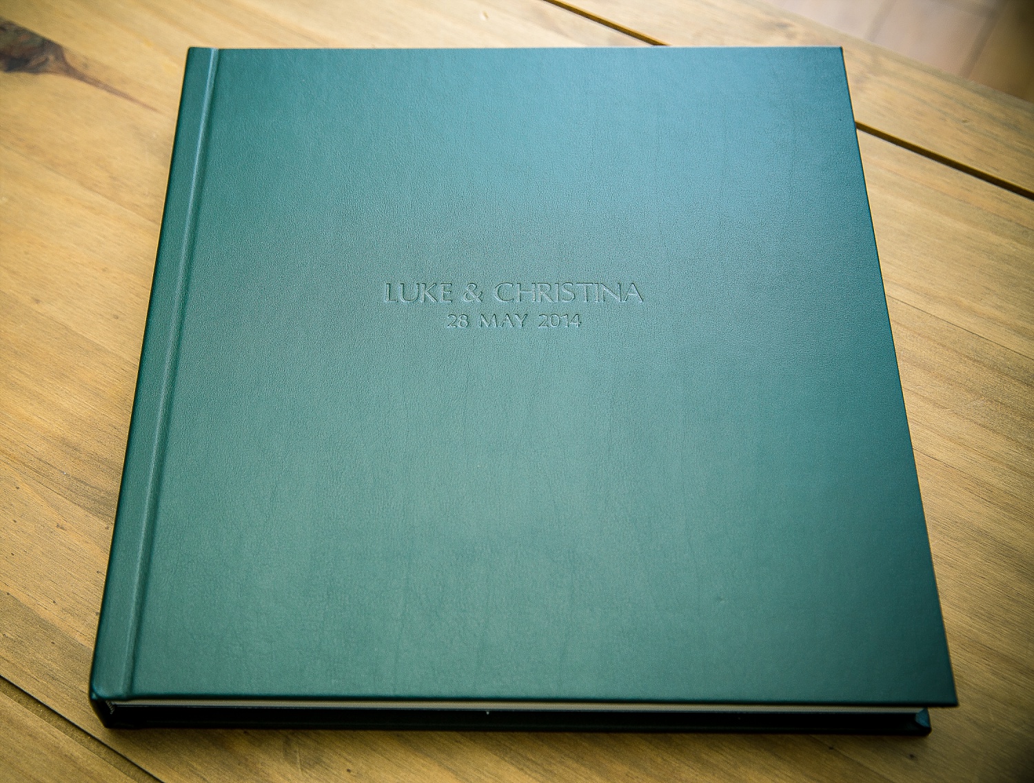 Green leather album cover with blind embossing