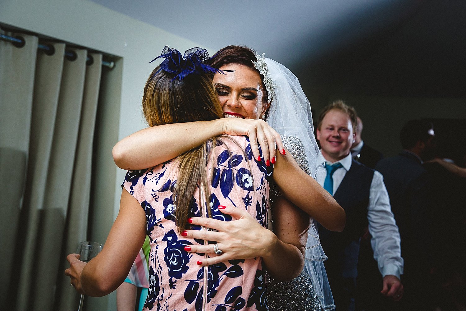 Houchins Wedding Photographer Bride and Guest Hugging on the Dancefloor