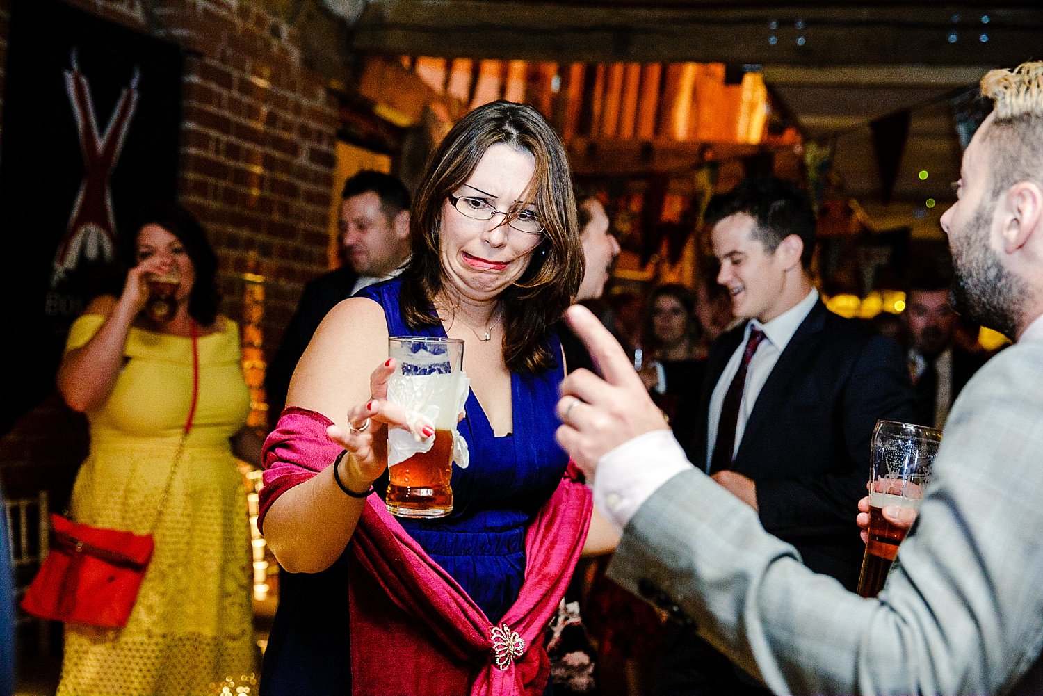 Tudor Barn Wedding Guest Spilling her beer on the dancefloor