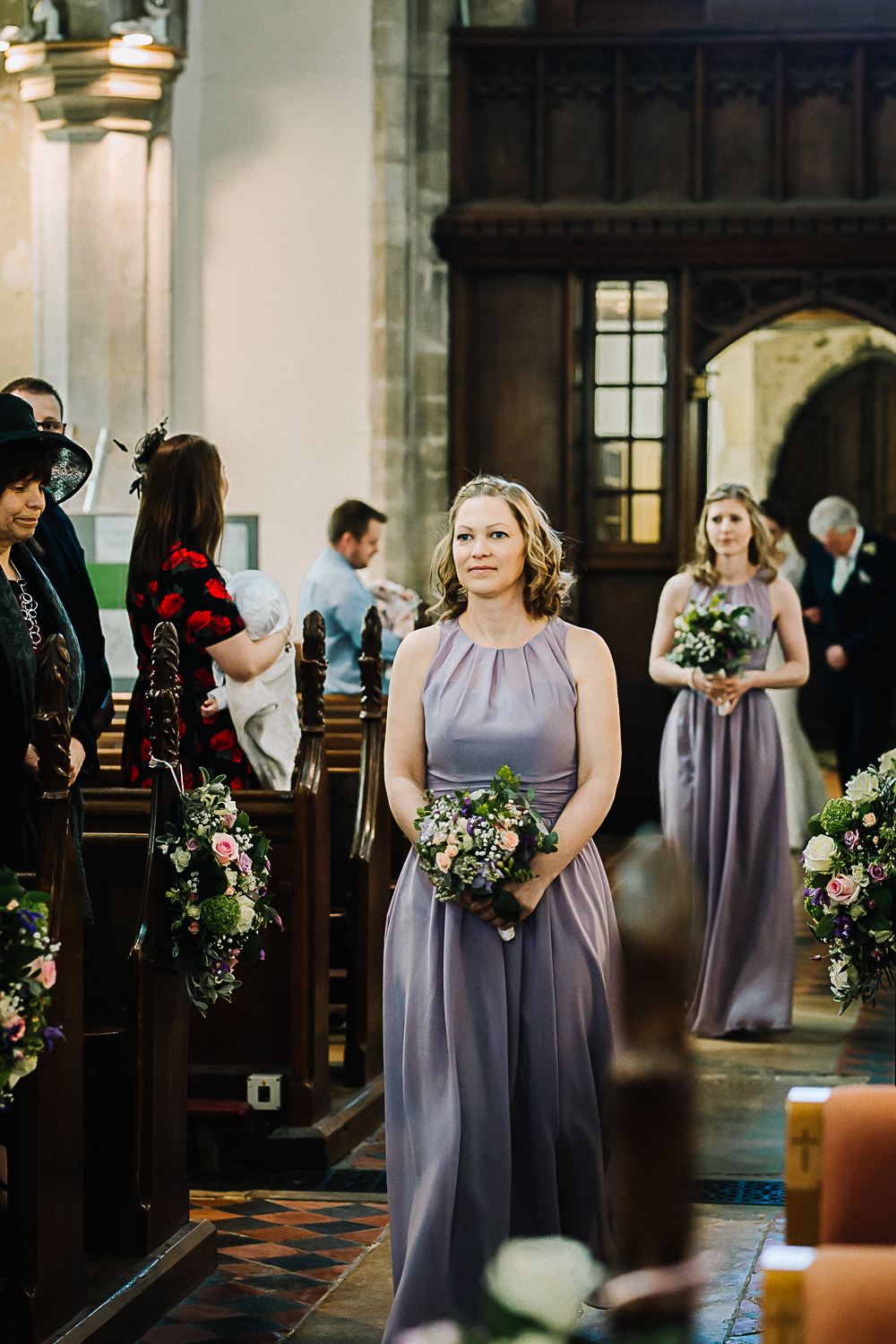 Bridesmaid Walking Down the Aisle at Cottenham All Saint’s Church - Swynford Manor Wedding Photographer