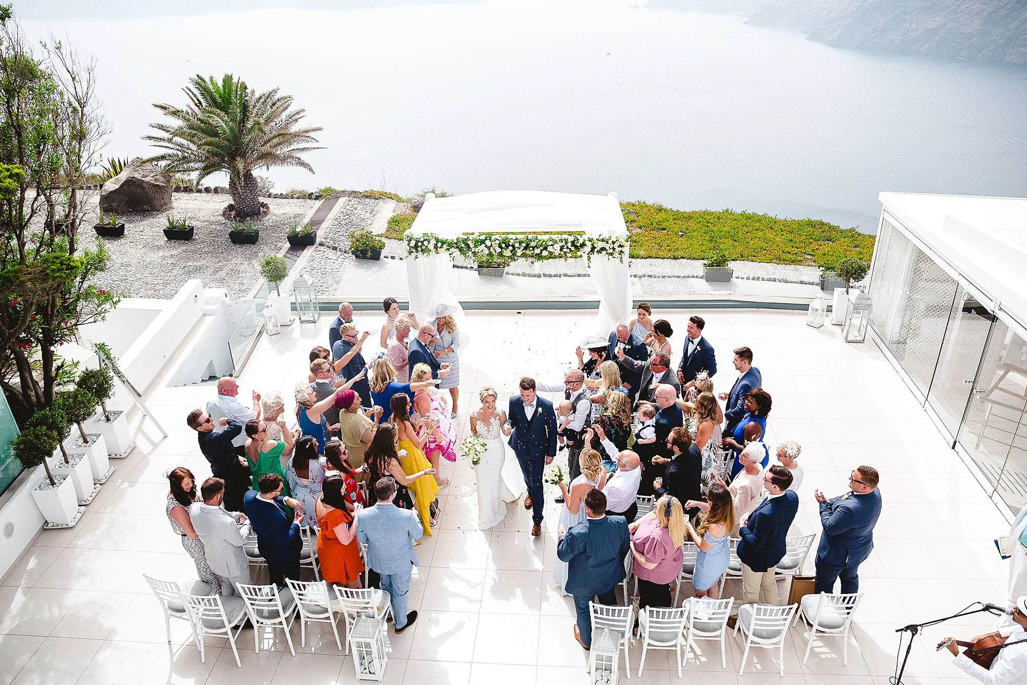CONFETTI AFTER THE OUTDOOR WEDDING CEREMONY IN SANTORINI GREECE
