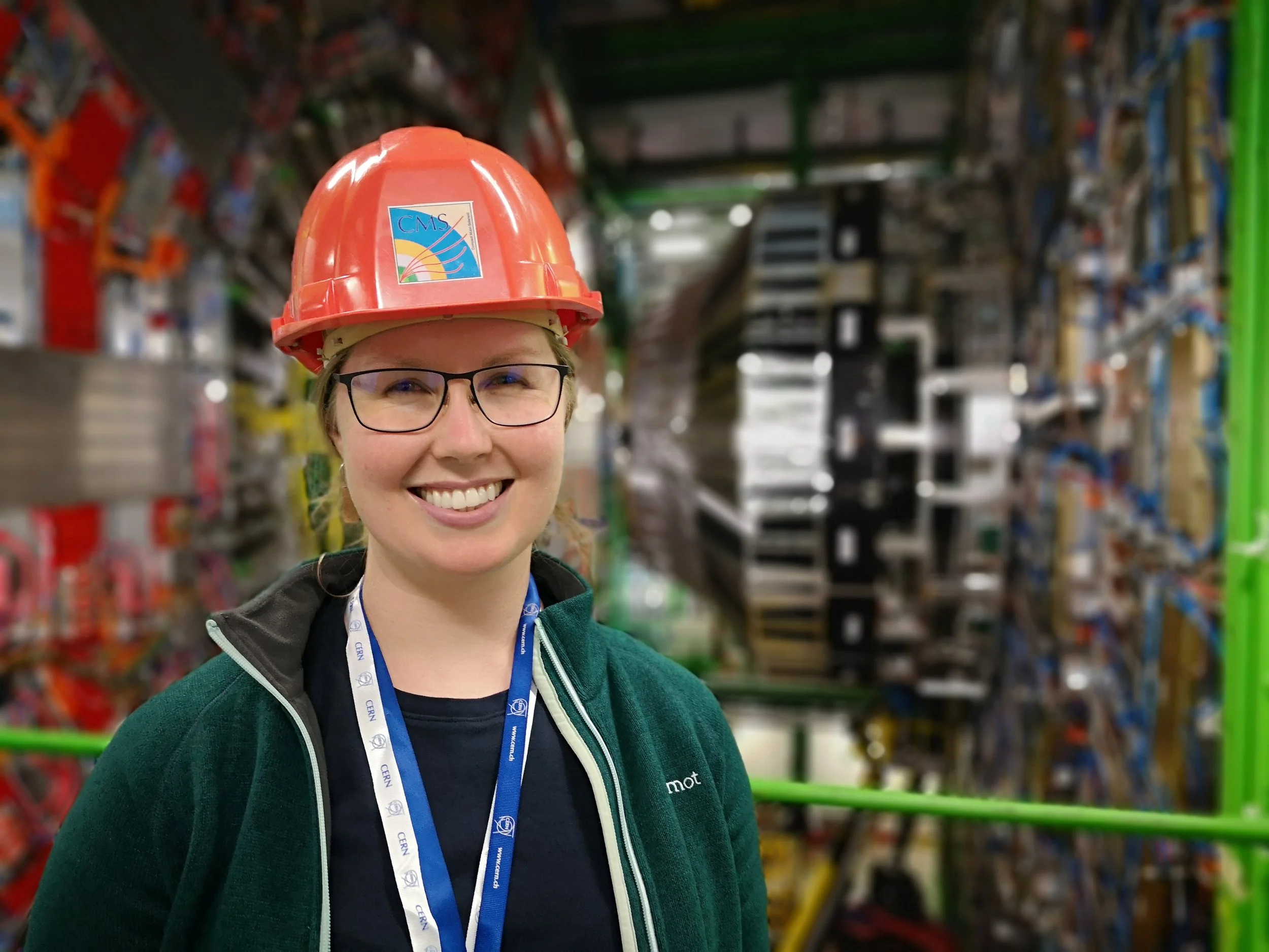 Katherine Kornei in front of CERN's Compact Muon Solenoid CMS detector.jpg