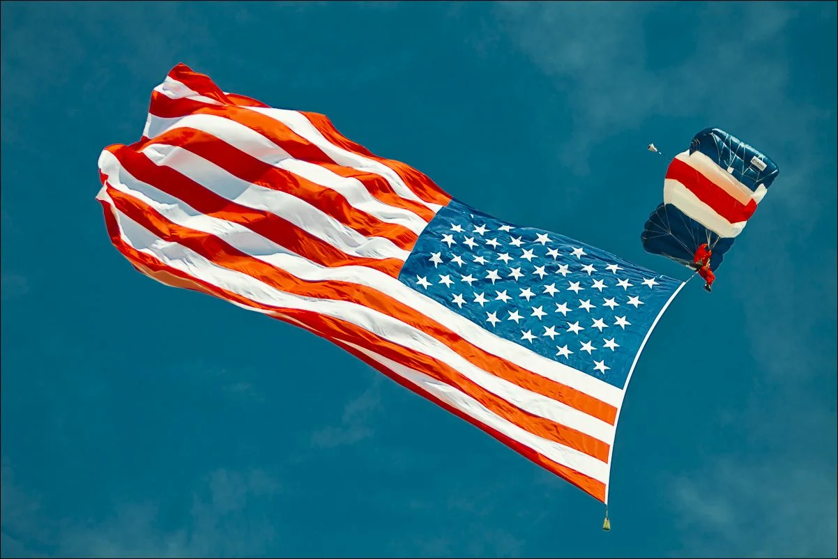 Always a crowd pleaser, the American flag arrived by skydiver.