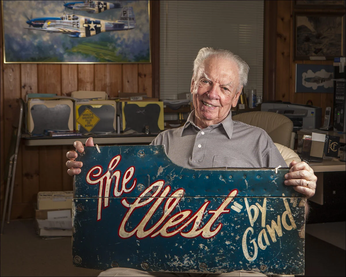  Bob "Punchy" Powell, who holds a piece of the cowling from his crashed P-51 Mustang