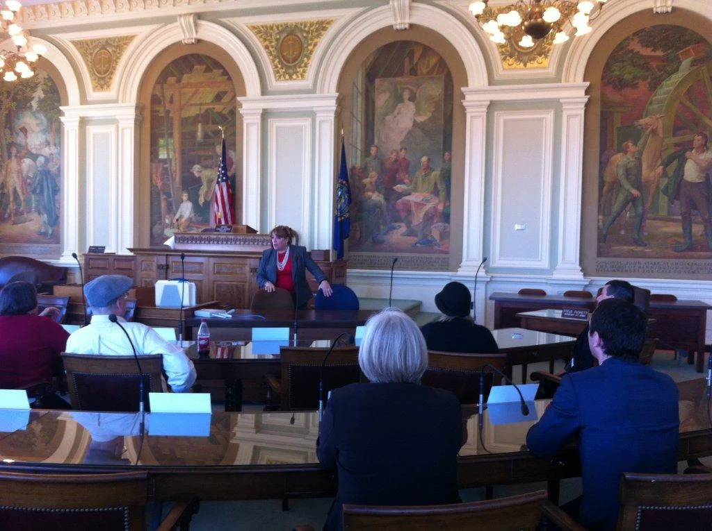 Virginia Drew guides our group in the Senate Chamber