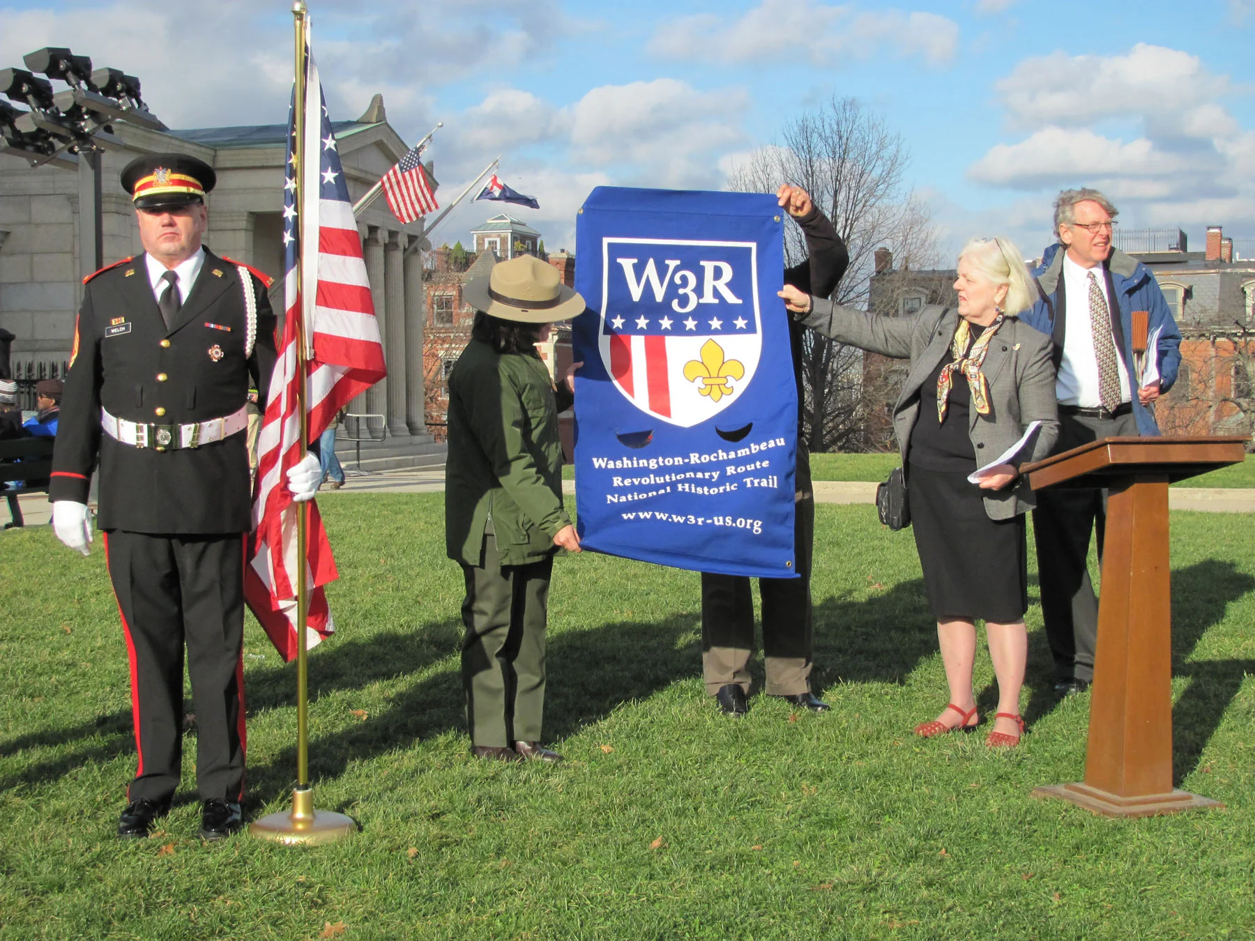Ursula Reed of W3R presents a banner to the Deputy Superintendent Celeste Bernardo, 2011 W3R Lafayette Society.