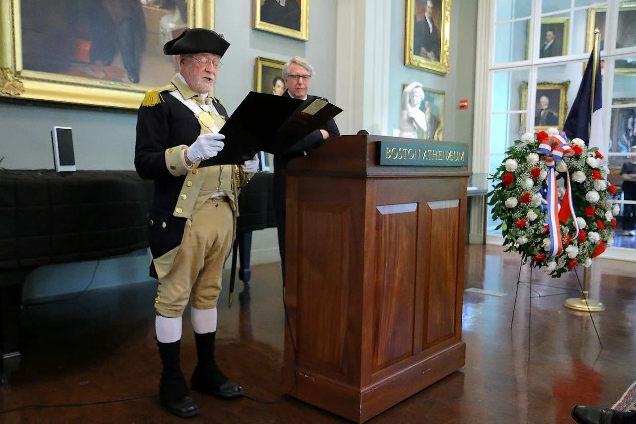 Minuteman Bill Poole reads the Governor's Proclamation in English