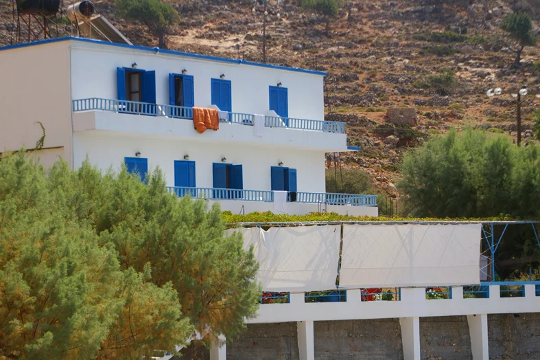 Main building with hotel rooms above big terasse