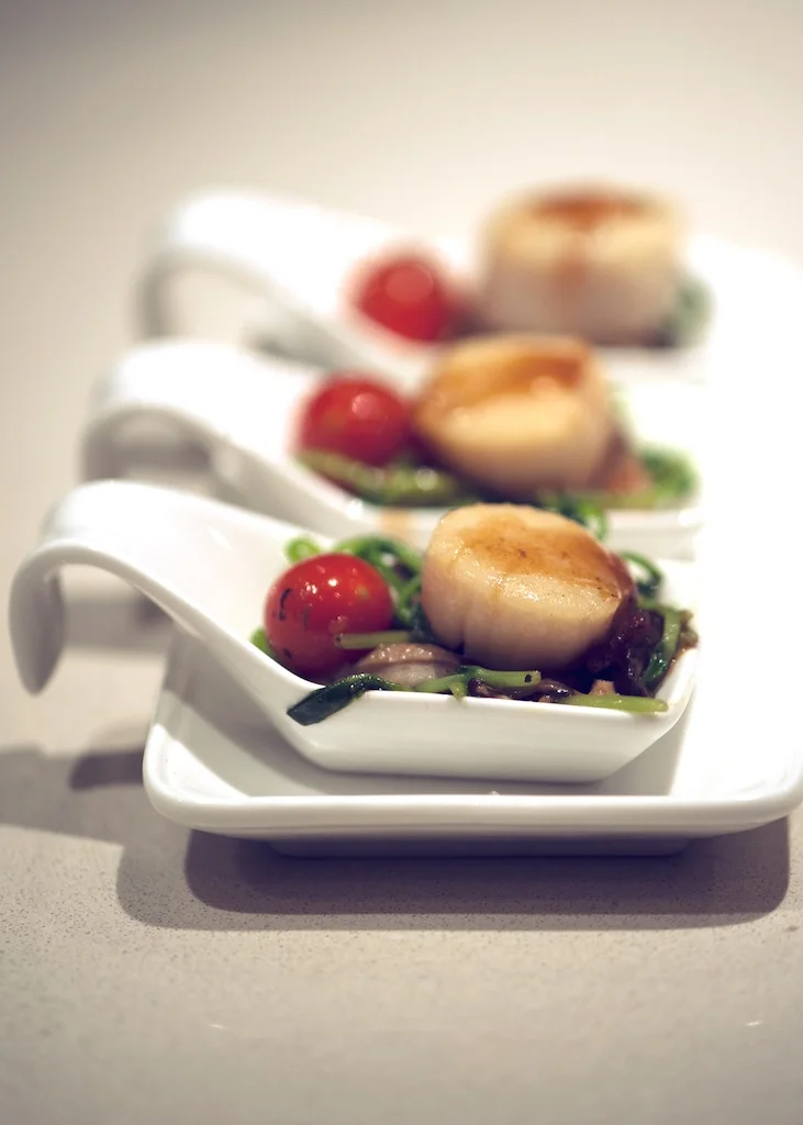 Scallops with pancetta, pea shoots and cherry tomato
