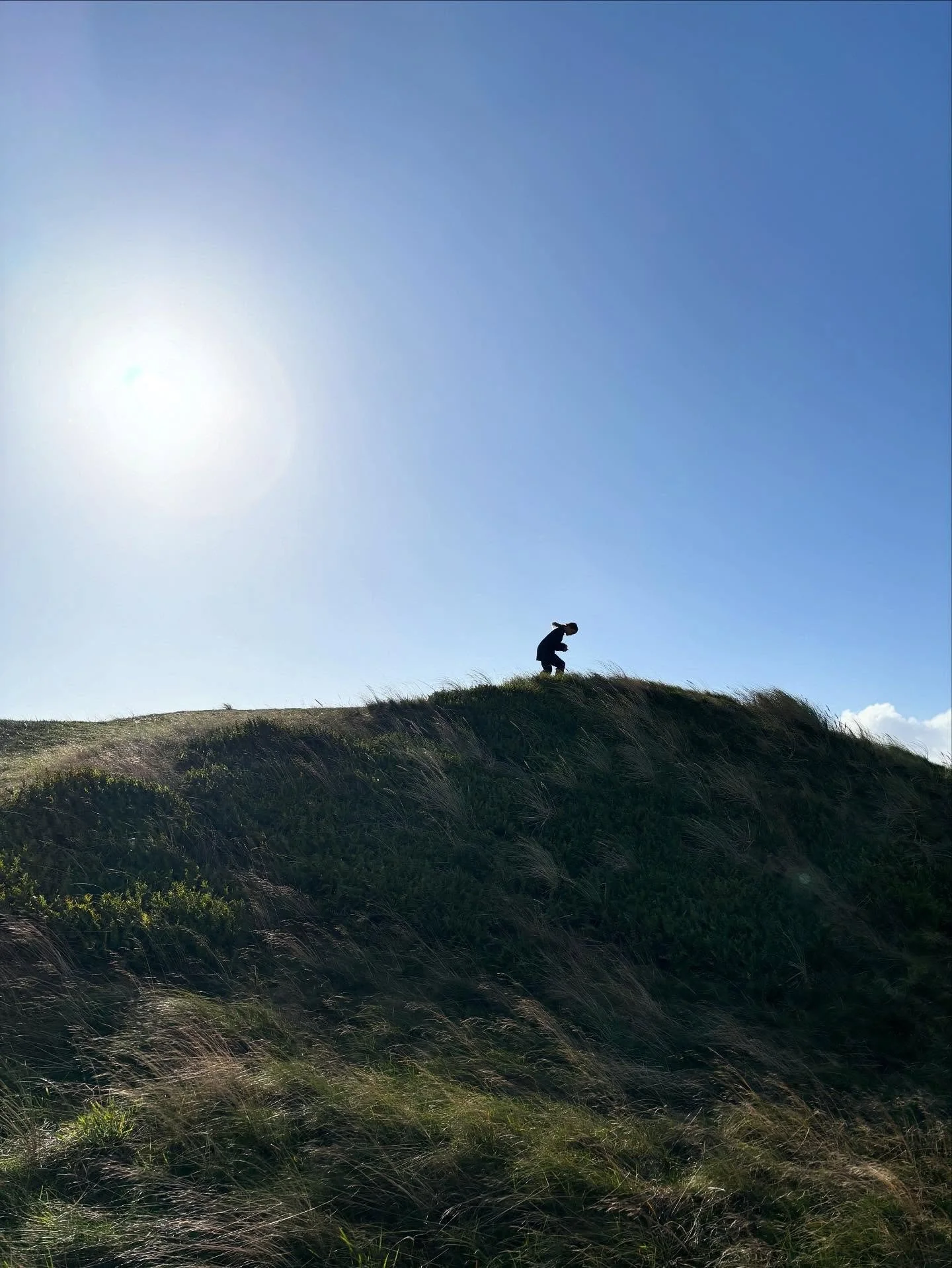 A child on a hill. My child. The youngest one. Adventuring on home ground. Nourished by time, wind, drives on the ocean floor and a ghost walk after sunset.
Starlings in the sky. 

For once things feels slowed down in the best way possible. 

As far 