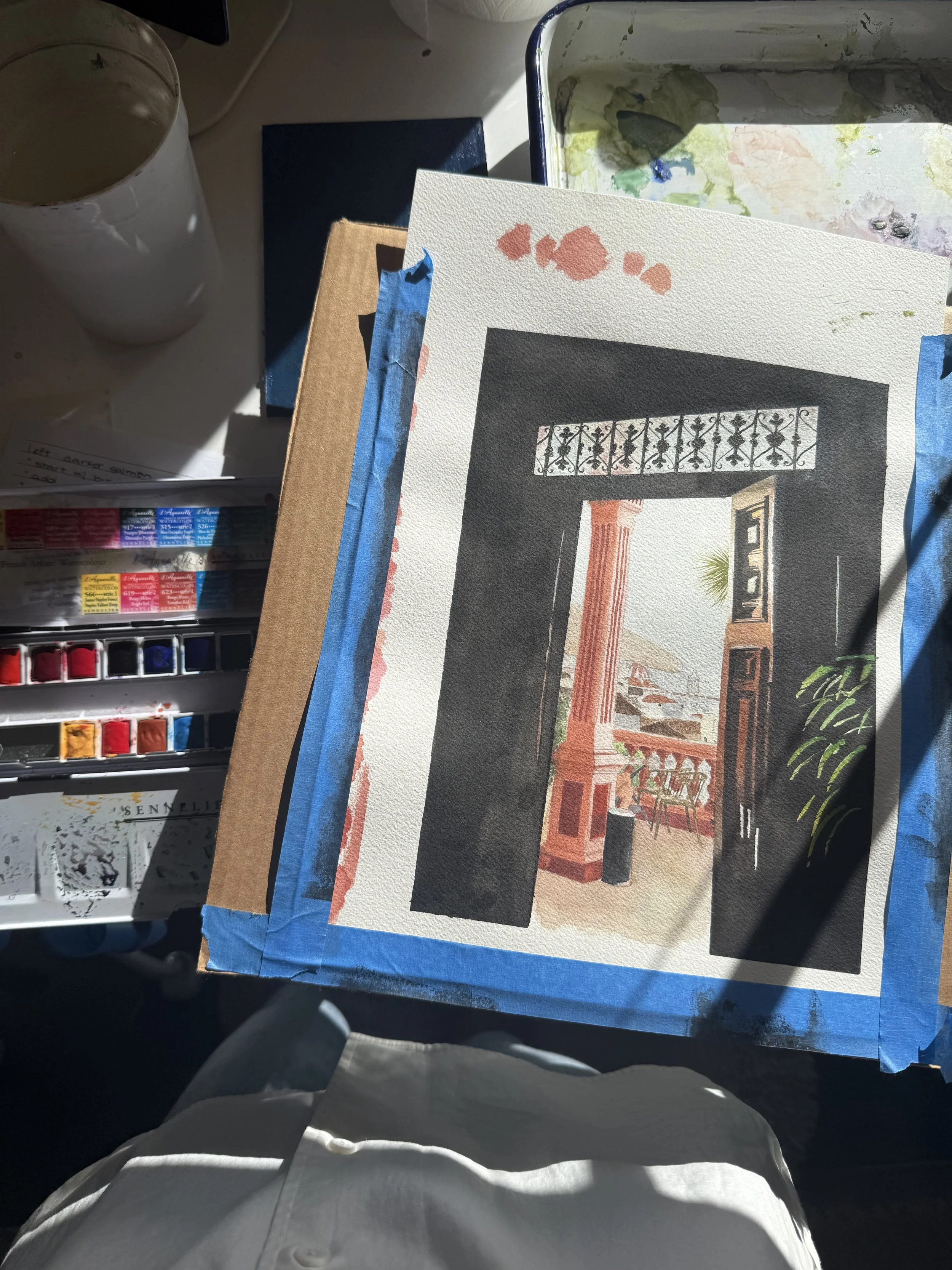 Aerial view of a watercolor painting in progress.
