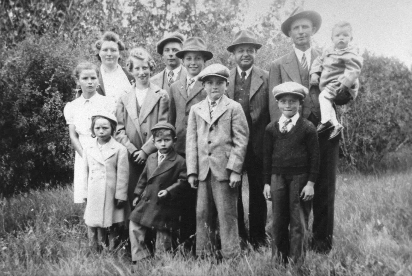 One of my grandfather's many family photos. My dad is to the right of the blond girl in the second row.