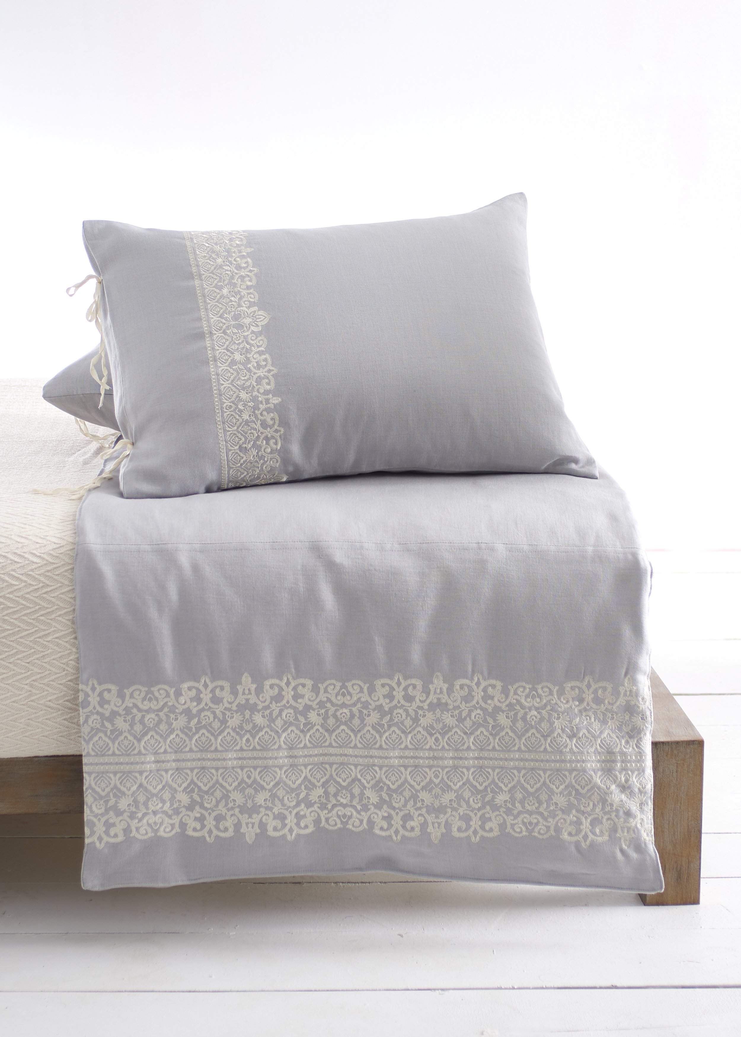 New Item — Marrakesh Counterpane . Our Counterpanes are decorative accents that are about 1/3 the height of a duvet or comforter and are placed at the foot of the bed and have matching shams that can be purchased separately. Counterpanes come in 3 sizes—Twin, Full/Queen, and King. Our Counterpanes are filled with alternative down. Our Marrakesh Counterpane is grey Belgium linen with ivory embroidery and the matching sham has natural twill cotton tie closures.