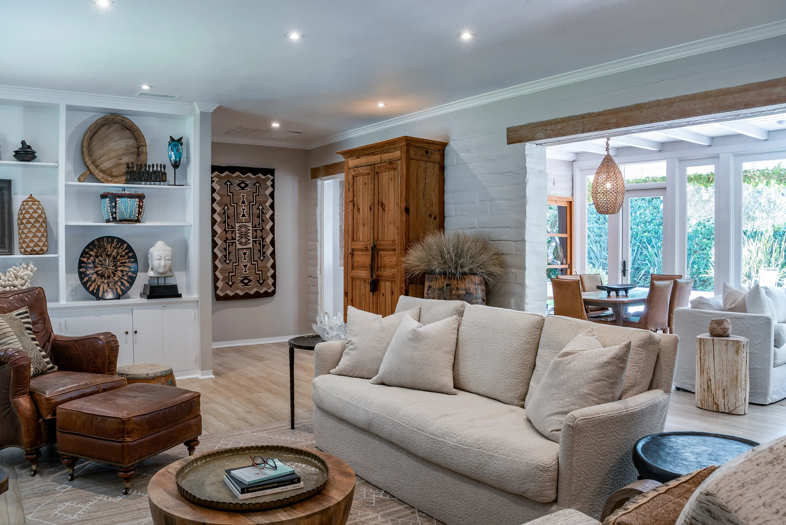 My use of old and new in the living room creates a friendly, inviting feeling—casual elegance. The monochromatic background is punctuated by natural elements of leather, reclaimed wood, rock crystal, textured linens, carved marble, and a complimentary collection of various authentic ethnic pieces.