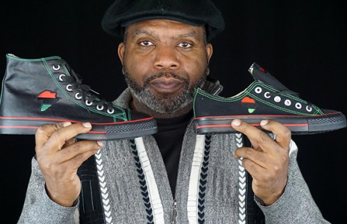 Tariq Edmonson, founder of SneakersCustom.com, poses with his custom-designed African sneakers
