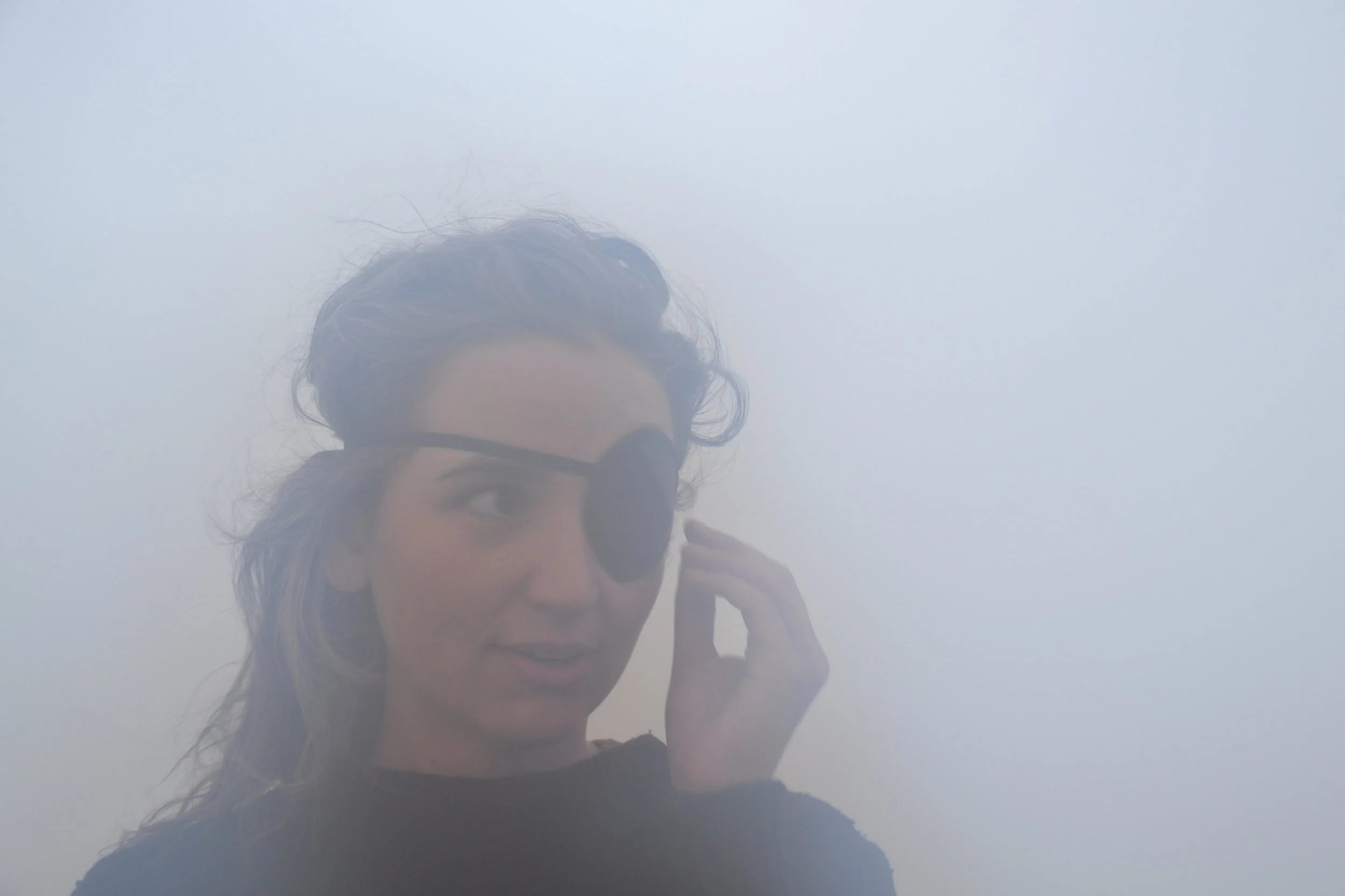  Nicole Kouri is a young photographer and social worker from New York. Because of a slight issue deficiency in her eyes, she is unable to close just one eye. To compensate, Kouri wears an eye patch to focus on the camera and its settings. She shows o