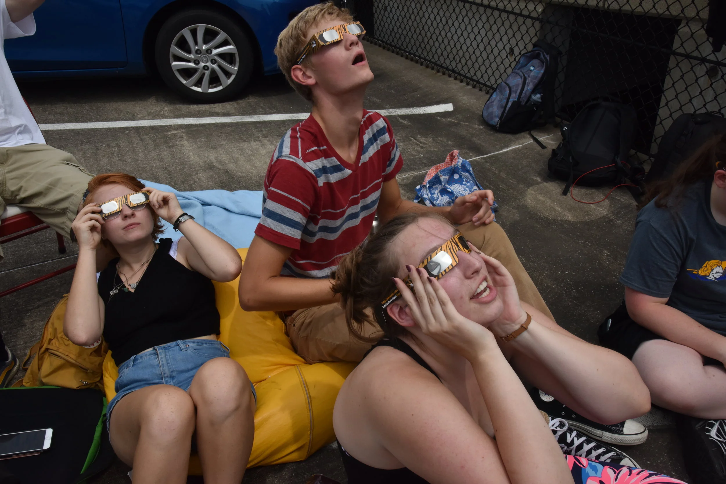  Mizzou students Zoe Rich, left, Haley Anderson and Nick Sondermann gaze at the solar eclipse on August 24, 2017 through Mizzou solar eclipse glasses. It was the first solar eclipse seen in Missouri since 1869.  August 21, 2017 