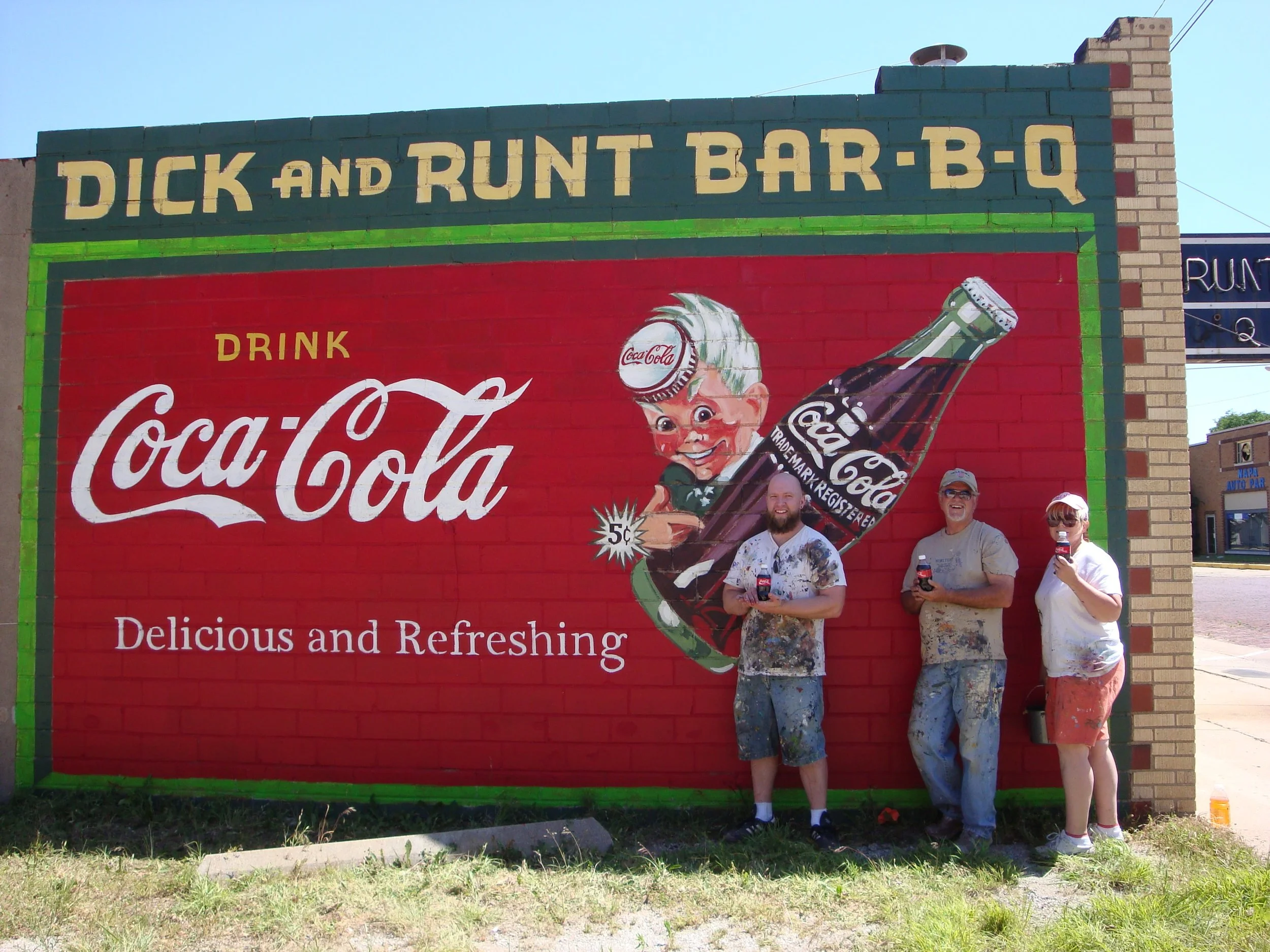Photo by: Ponca City Main Street of muralists that repainted a historic ghost sign. Triva: What is the name of the elfin character? ...Sprite!
