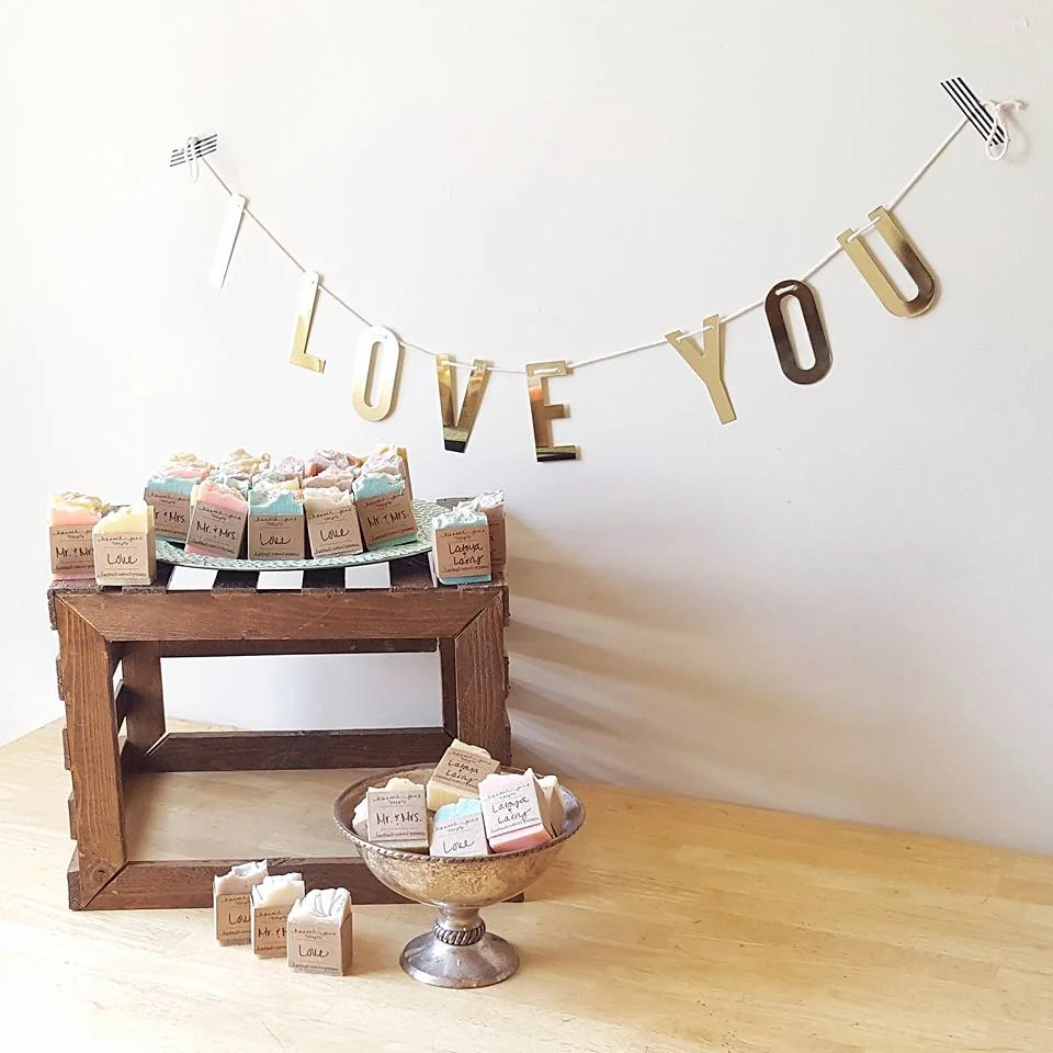 For this shower, they decided on a variety of scents with the labels reading, "Mr. & Mrs.", "Love" & "Latoya & Larry".