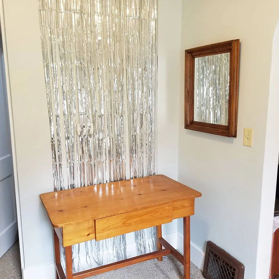 I moved this desk to have a small table top to decorate and found the silver backdrop at Target for $5.
