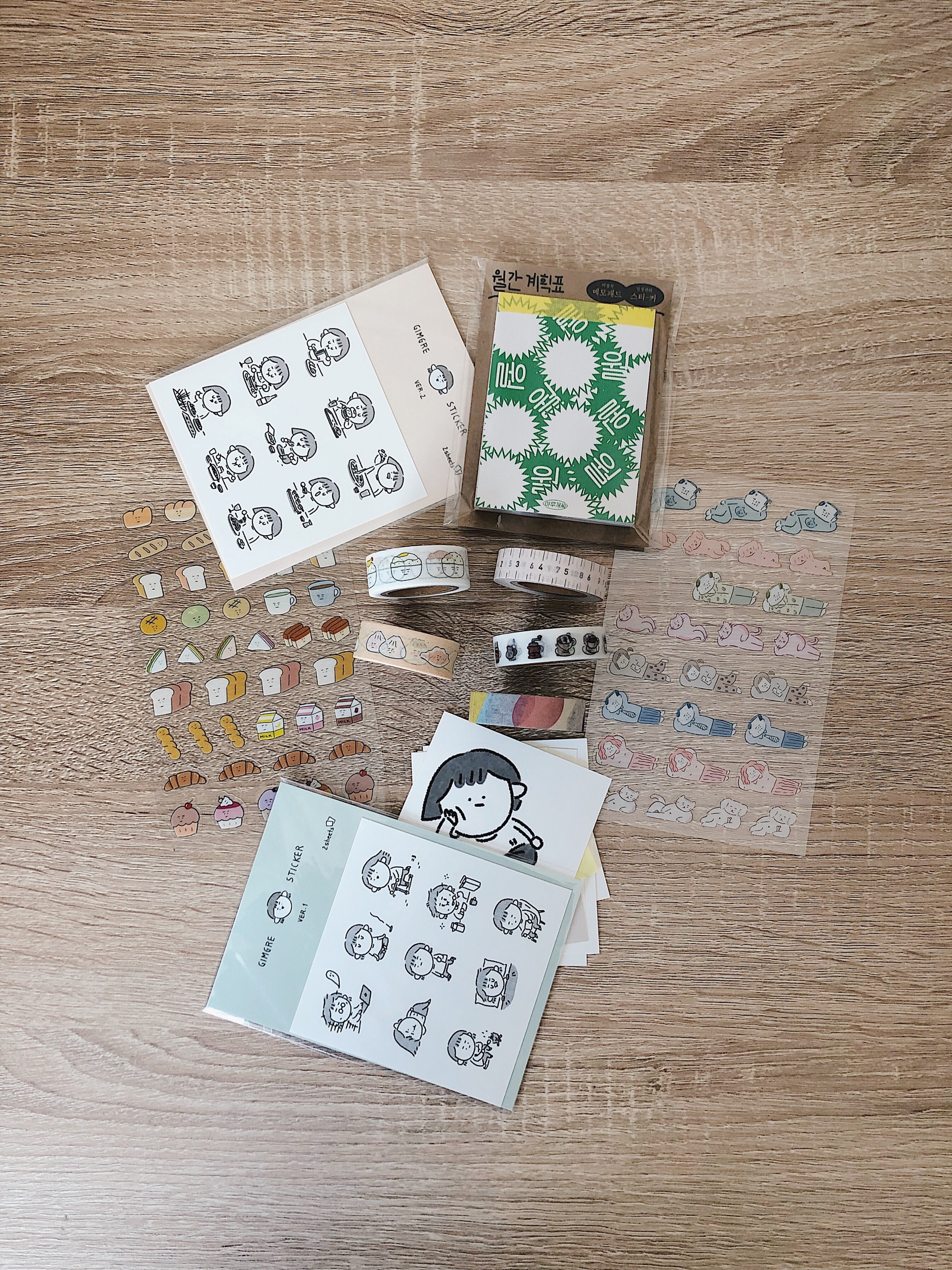 Top center: green monthly memo pad by Ahmugae-c Sticker sheets: hand-drawn stickers by Gimgre, bread stickers by Bakban Design, "family lying down” stickers by Ajassi Masking tapes: rice and dumpling by Bakban Design, coffee by 3months, pink ruler and patterns by oh, lolly day!