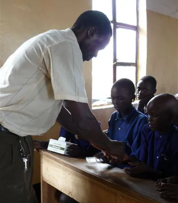 Handing out de-worming tabs at school