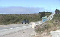 Highway 1 looking north toward Davenport. Note the straight, flat line atop the bank on the left. That's the railroad grade atop the Rampart. Both the rampart and the fill upon which Highway 1 was built are artificial. The original grade of San Vicente Creek is well below both of them. 