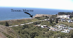 The two ramparts of San Vicente Creek at Davenport. The straight line on the upper left is the Railroad Rampart, while the lower rampart of Highway 1 and its stream of cars is just below it. Imagine if the San Vicente tunnel were blocked, the resulting lake would flood the highway and all of the buildings in the center of the photograph.