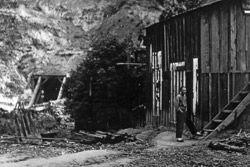 Rare photograph taken c. 1885 outside the tunnel mouth. "Off-duty" Chinese railroad worker on right is wearing slippers and a queue