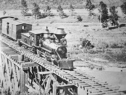 Trestle crossing Soquel Creek at present day Capitola. The creek is in the foreground, and the train is headed toward Santa Cruz.