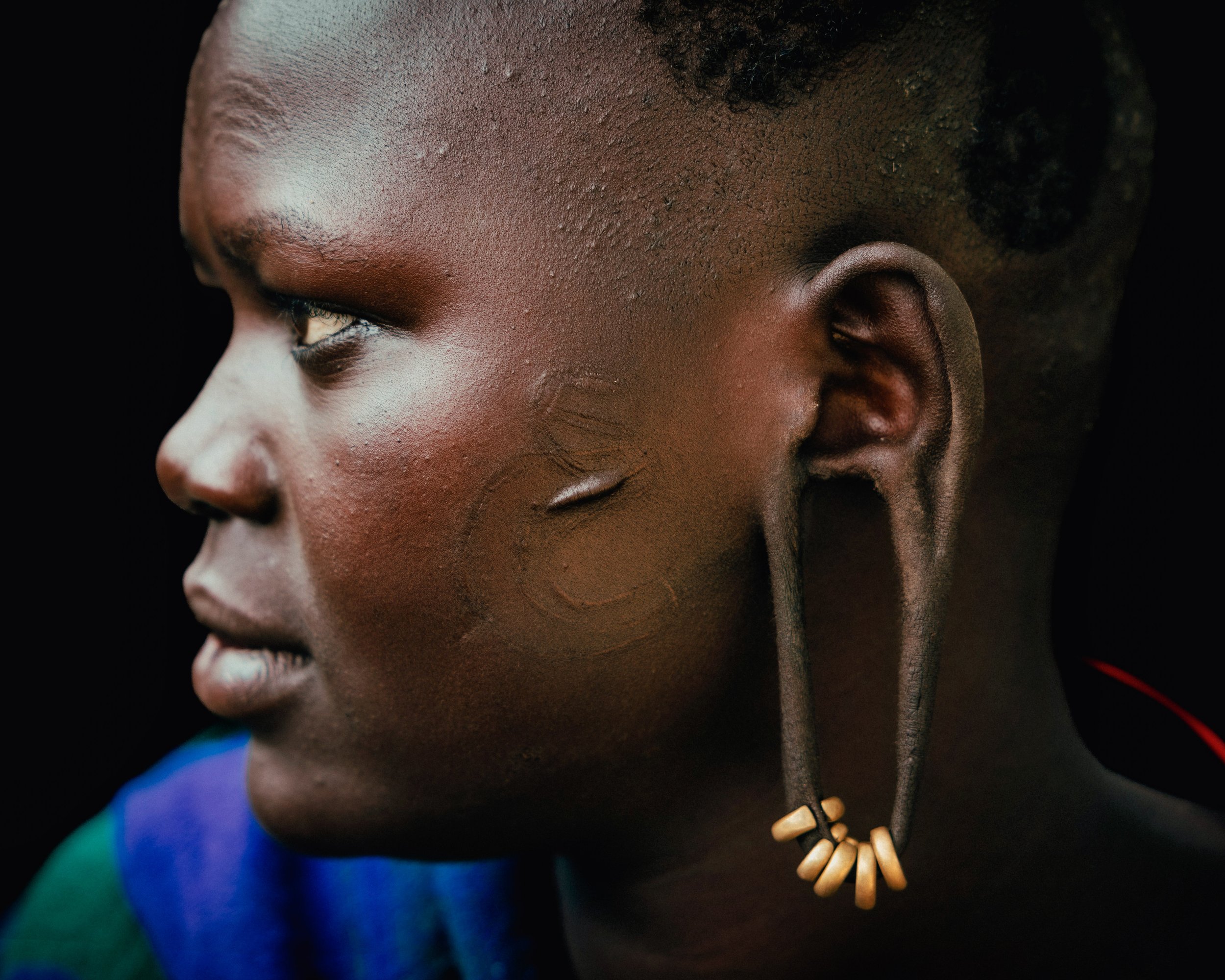 Andrew Eldon_Profile of Suri Woman Ear_Omo Valey, Ethiopia 2023_Courtesy of Blue Lotus Gallery
