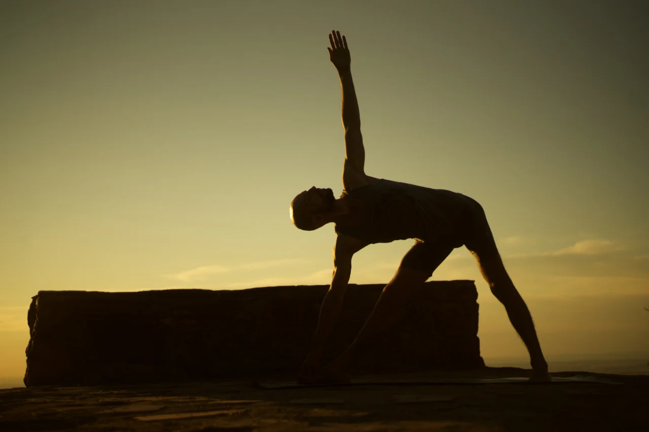 the subtle balance between the basic pattern of prana and apana – which manifests through the breath – informs action and counter-action within any given posture. thus, building the posture from the inside out by finding the delicate play between ease and groundedness. Trikonasana A by Dmitry Baryshnikov shot with Sony A7 with and adapted analog 50mm f/1.8 Nikon prime lens. yoga to the people.