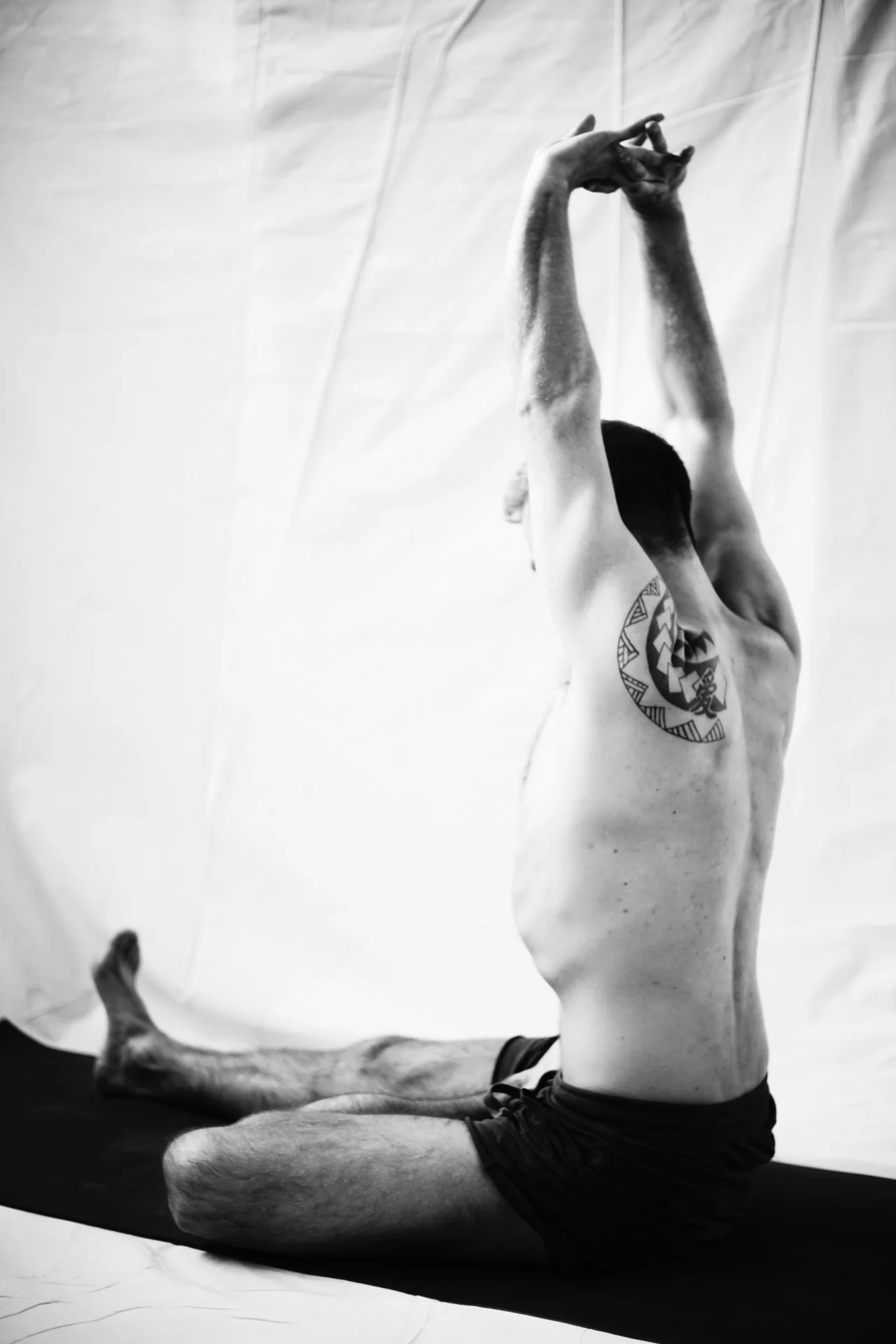 asana sthiti of ardha badha padma pascimottanasana. the chin tucked into jalandhara bandh and arms raised over head with fingers interlaced help to connect to your breathing patterns which will eventually lift the rib cage out of the pelvis so you can lengthen into the forward fold. kumbhakas can be explored here. either in asana sthiti or an external kumbhaka while folding in.