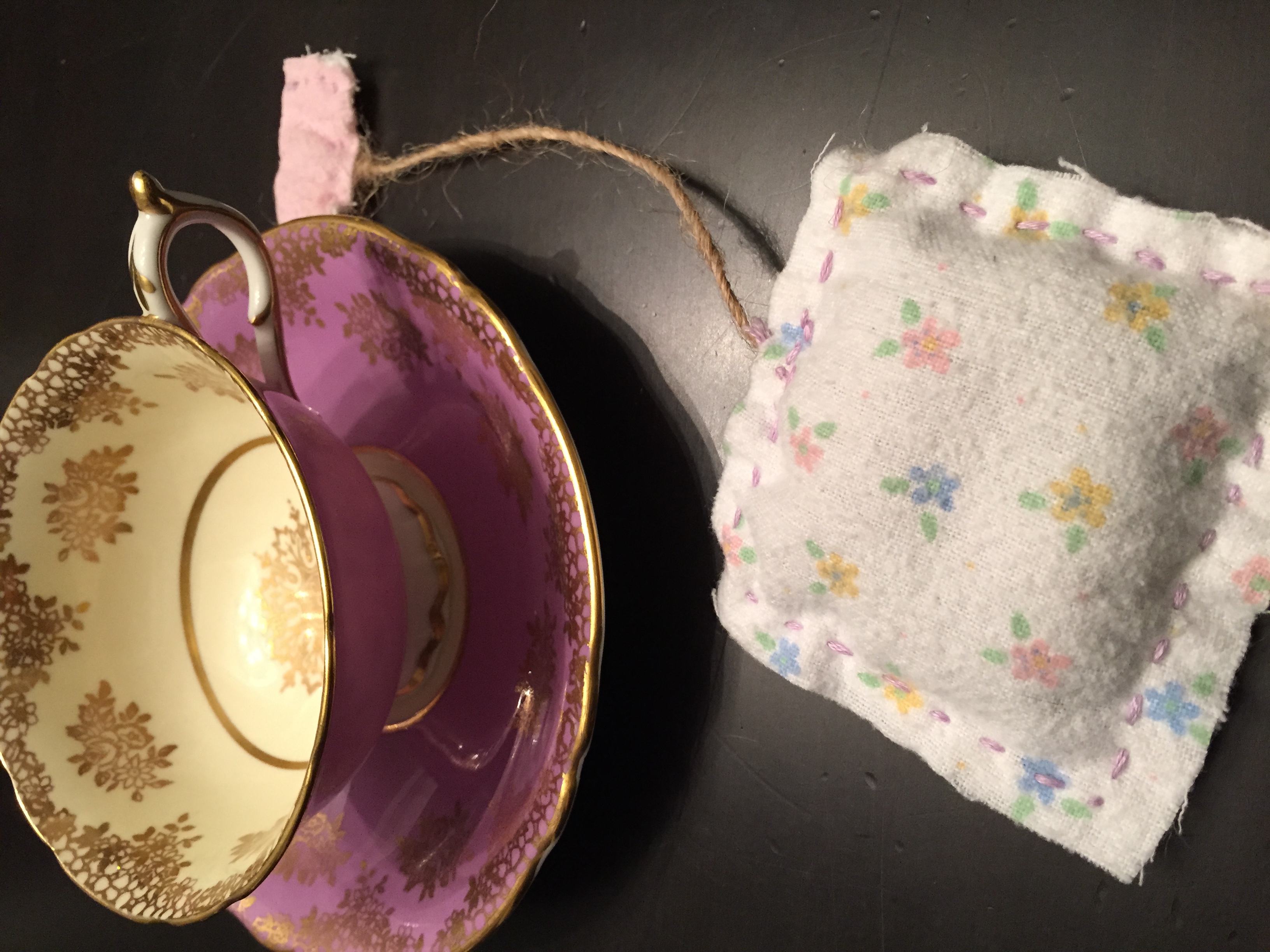 This is a very special tea cup passed down generations to my daughter, not to be mistaken for ones we bought at Good Will. The cloth was different on each side of the tea bag, filled with lavender and sewn together by family and friends. Thanks Jay-Jay, Raleigh and Heather Dinger! Total cost per goodie bag: $2 for cup and saucer, $1 for lavender, cloth, twine and embroidery thread = $3 each for 12 girls - $36.