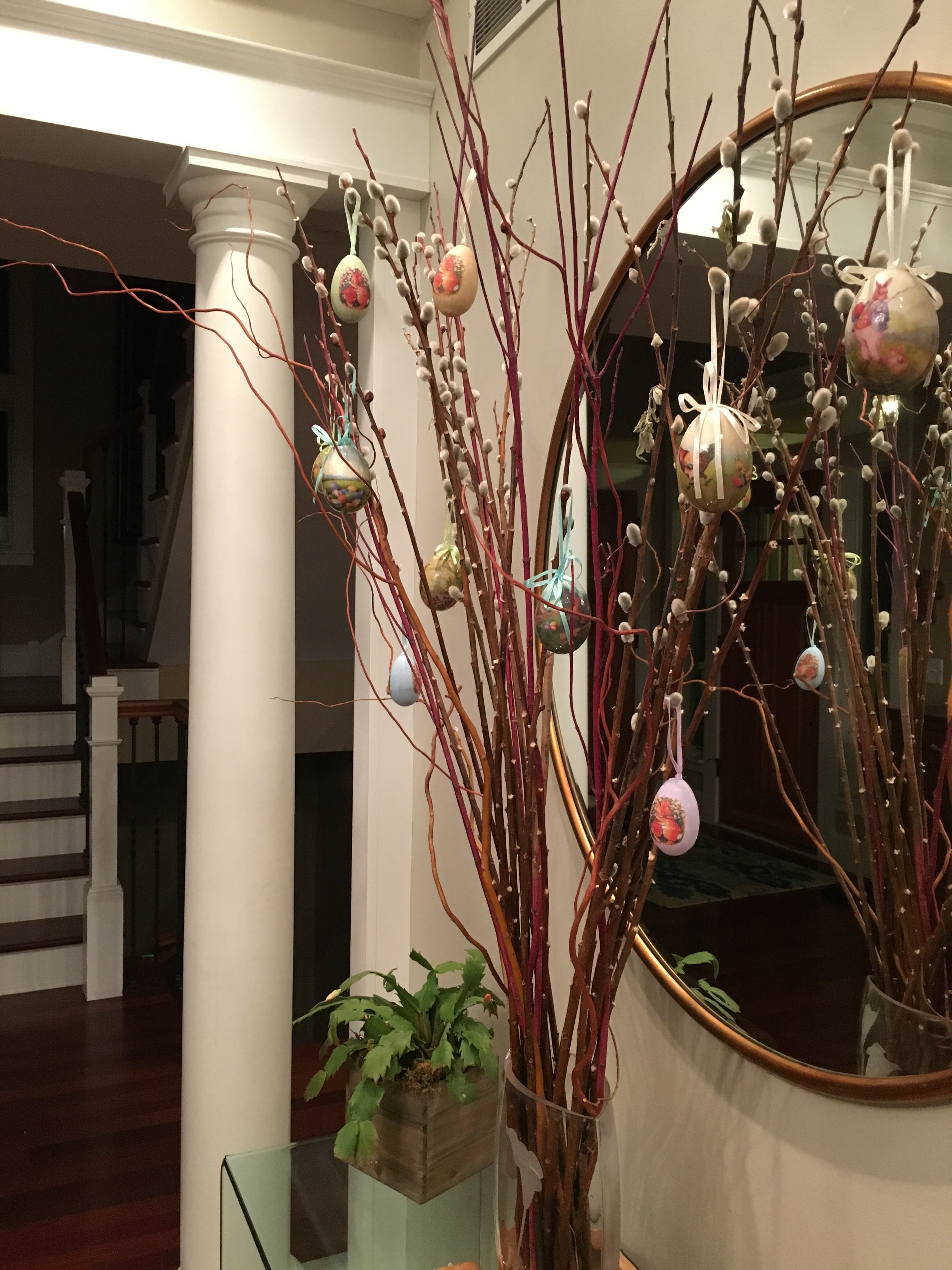 SIMPLE BUT STILL A STATEMENT. paper eggs hanging on the pussywillow branches.