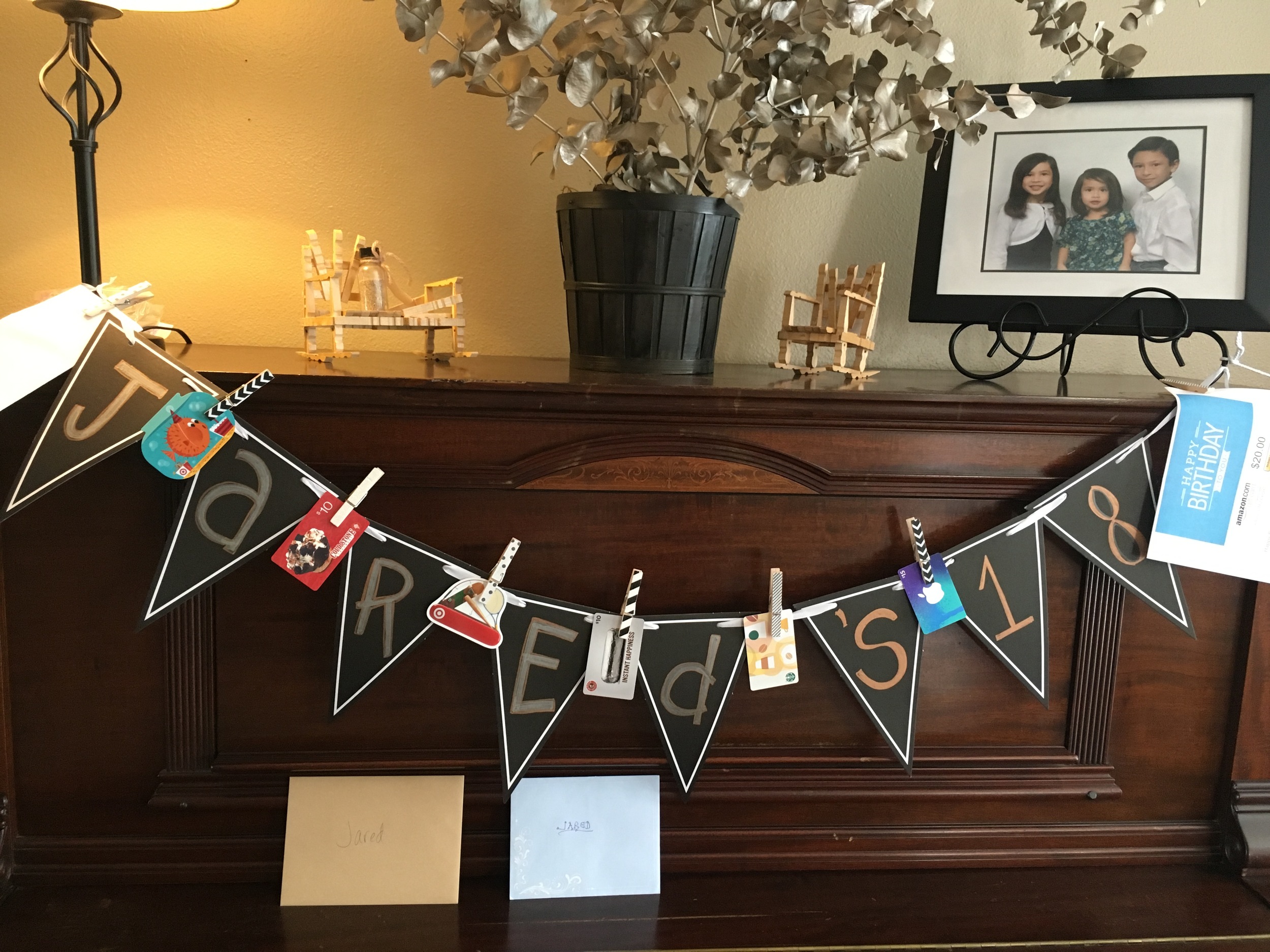 A good handful of our families do not live near the celebrants but I still extended the invitation to them. If they couldn’t make it, they could still be a part of the event by sending in a gift card which became part of a group gift for each celebrant. We hung the cards on banners that I got from Target with the cute black & white clothes pins on Jared's. As the guests arrived, more cards were clipped onto each banner. Notice even the babies banners have Thoughtful Pinches to Starbucks, ITunes and Cold Stone. Hey, the parents have to survive these days too!
