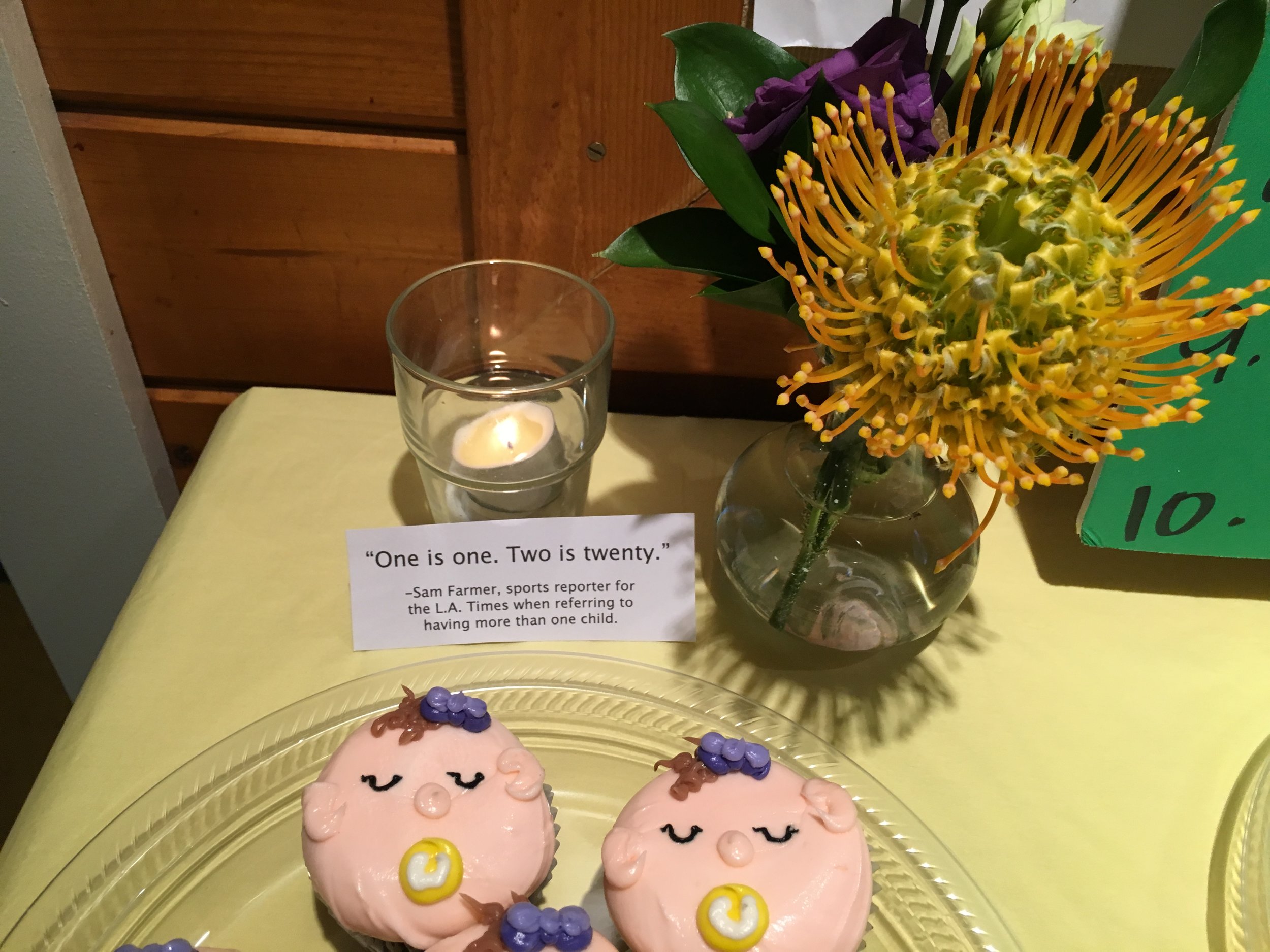 Dessert: The boy cupcakes had yellow bow ties with purple pacifiers and the girls had purple bows in the hair with yellow pacifiers. Sam Farmer and his wife Paige came to the baby shower when I was pregnant with my second. They wrote their "One is one. Two is twenty." line in my card and I have never forgotten it.