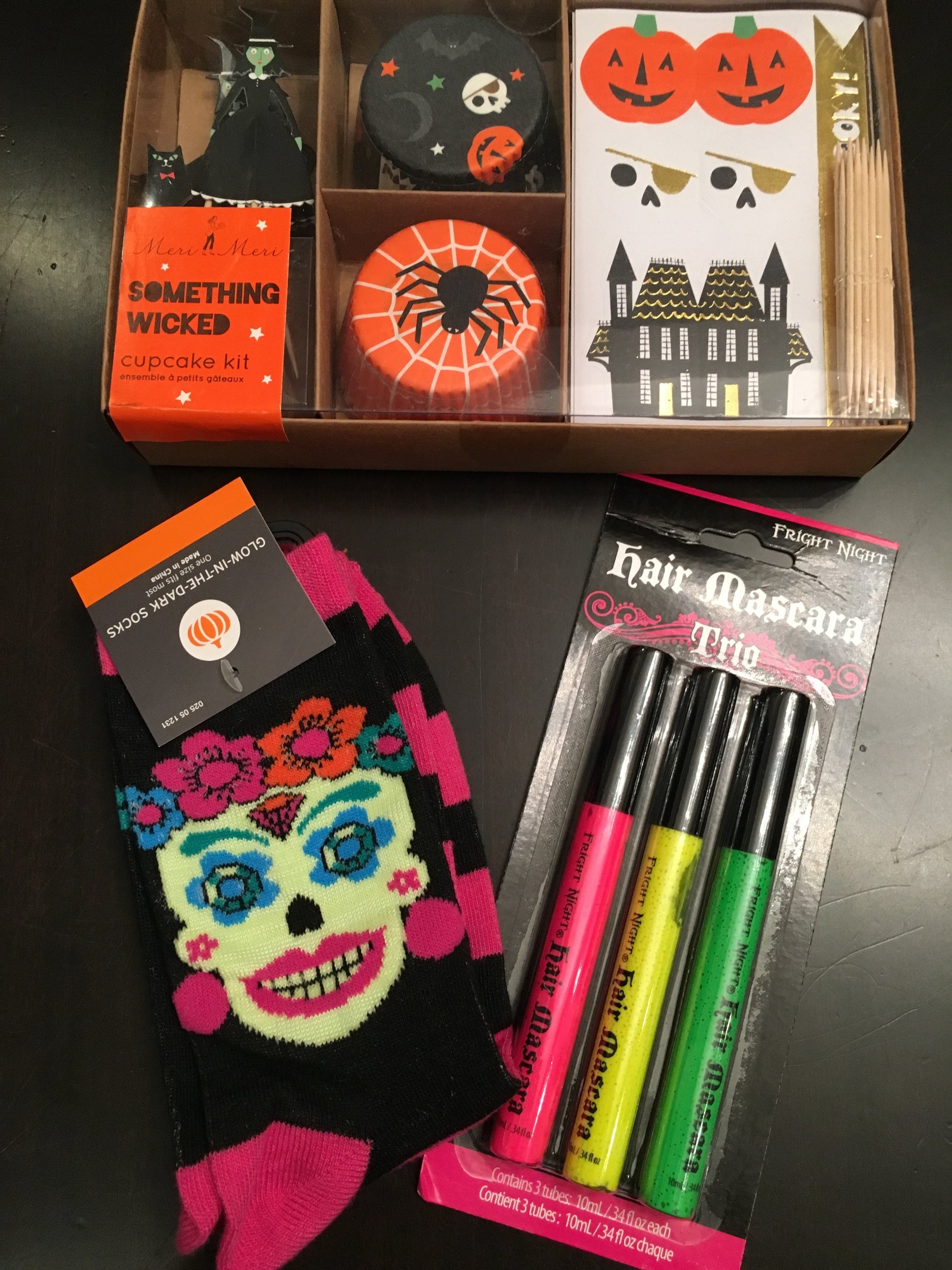 My daughter is dressing up as a Harry Potter Gryffindor student (thank you for not confusing her with Hermione). Her pinch includes: hair mascara, a cupcake kit and some "smell my feet" Day of the Dead socks.