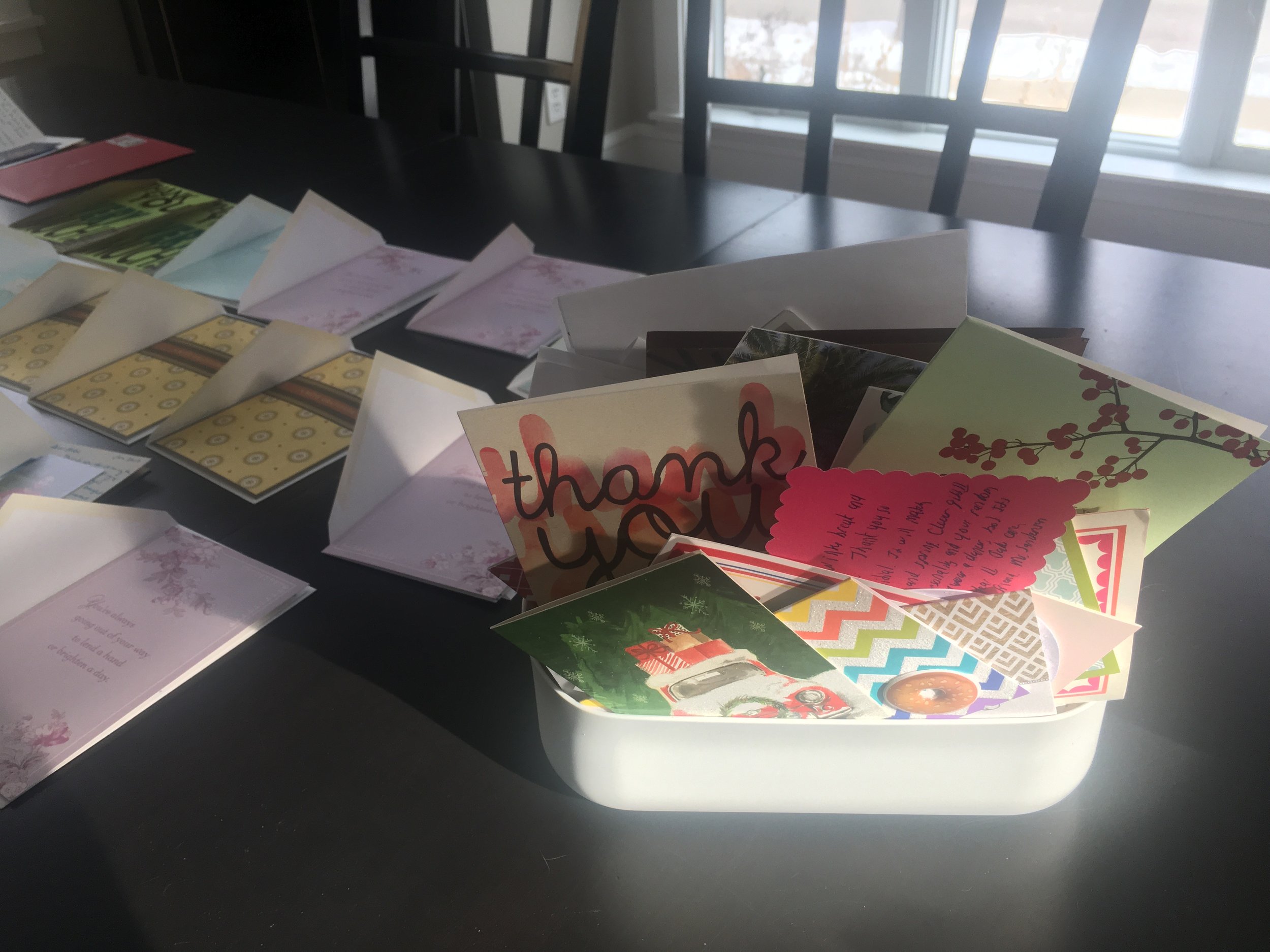 This little bin doesn't look like it but it held 107 thank you cards collected this year. Next to the bin are the cards we wrote for the kids birthdays and Christmas gifts getting ready to be signed and mailed last week.