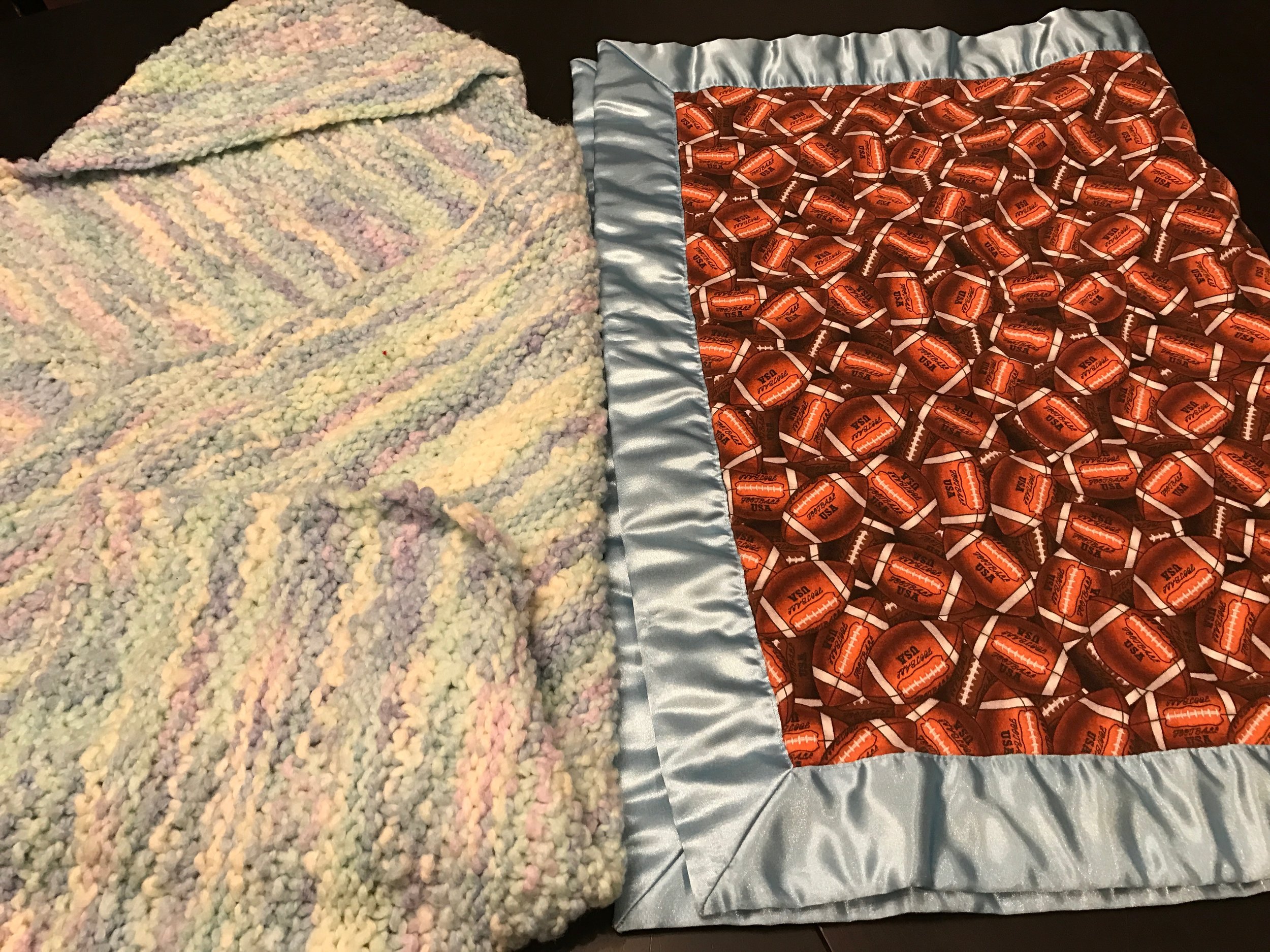 More sentimental blankets for my son: the blanket on the left has a hood and was from a BFF, Kristin. The football blanket on the right served us very well as our official stroller blanket and it was a gift from another BFF, Klaudette. It seems like he's more attached to it now then he was as a baby because, well, football. She gave a matching burp cloth too.