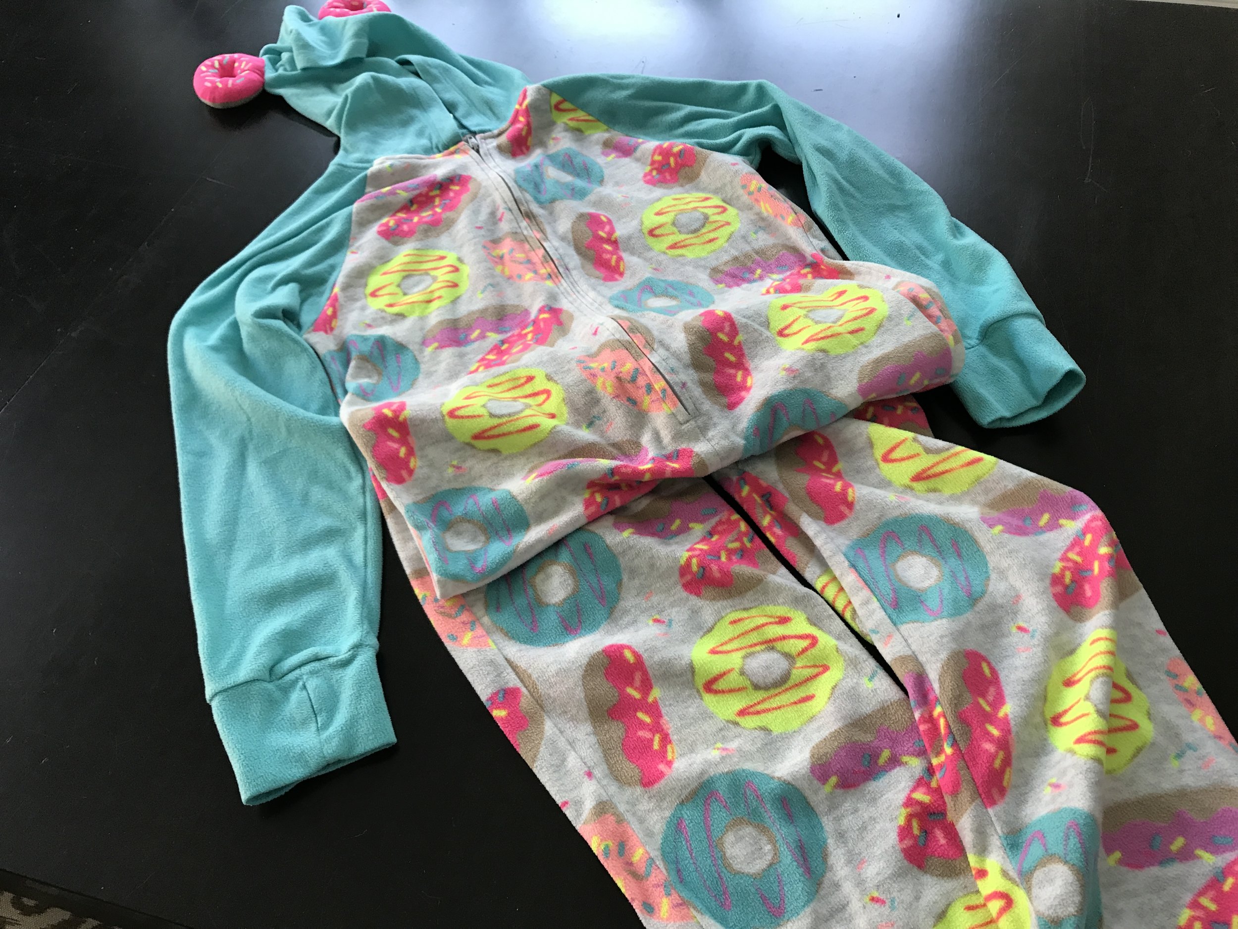 My daughter went to her first sleepover and the party favors included a personalized toiletry bag AND these awesome pajamas! It was as if each guest came home with birthday presents for themselves! Those are donuts, that look like ears, sewn onto the hood. Adorable!