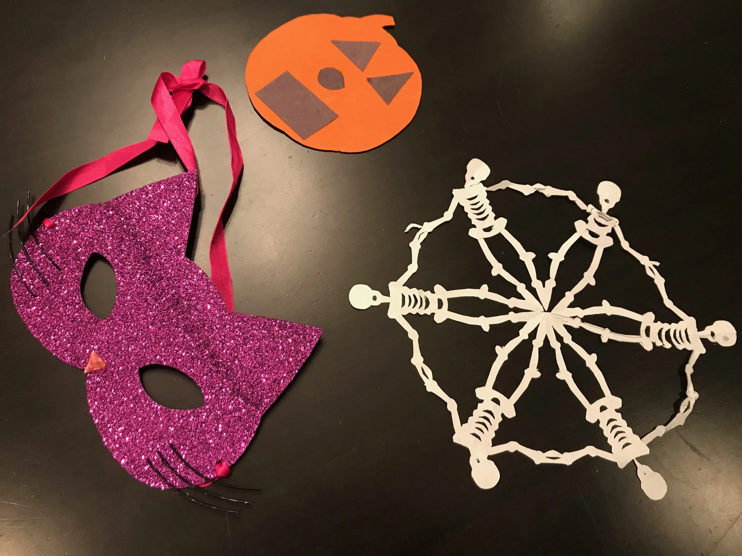 A cat mask from Auntie Camille, a jack o lantern from Jordan Martucci (who will be a doctor soon) and skeleton snowflake made by our neighbor Derek. 
