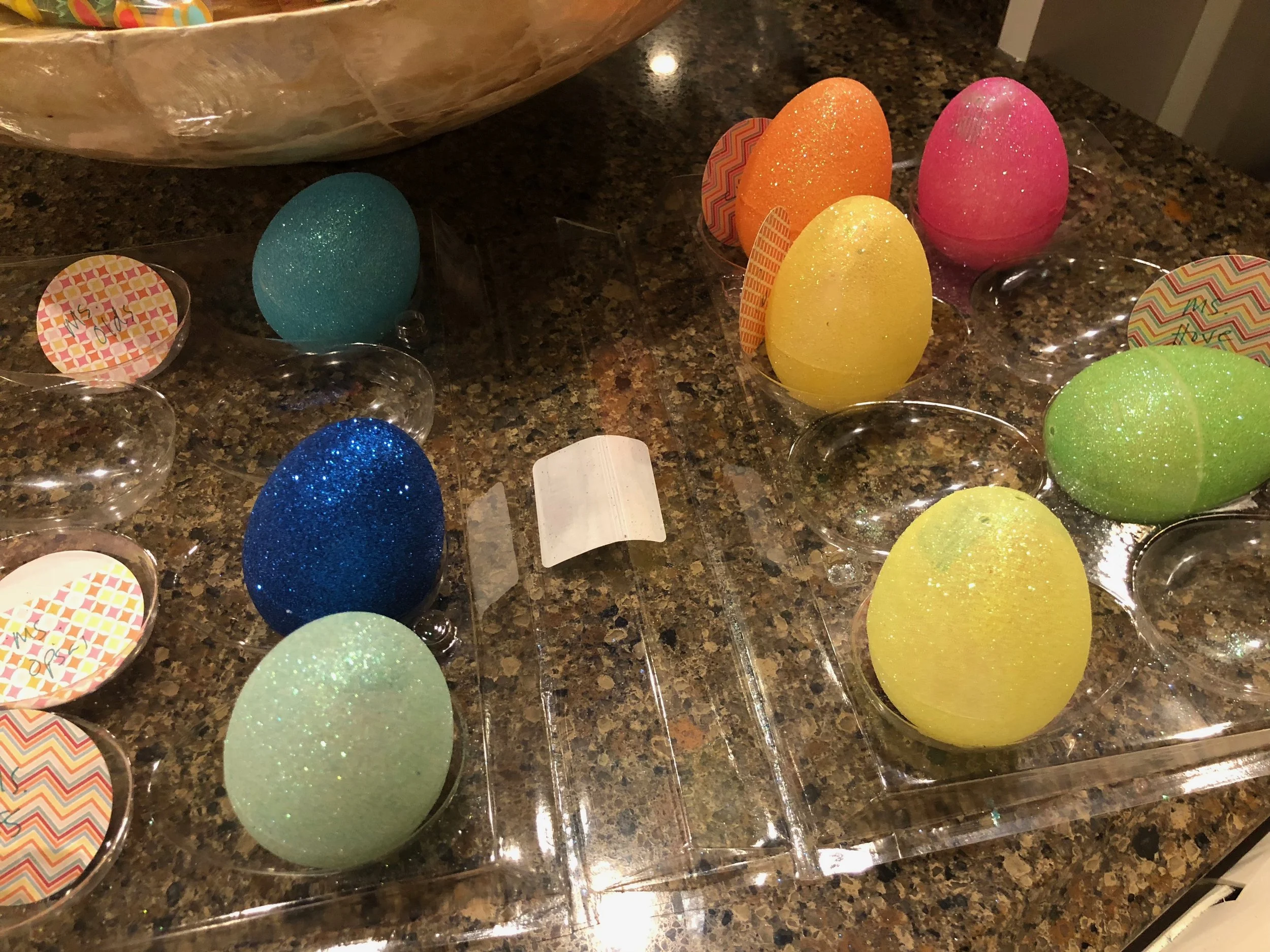 These plastic eggs had four holes - two holes on each half. I used washi tape to seal the holes from the inside. Then I used a strip of washi tape around the egg to make sure both ends stayed together. We found out that regular plastic eggs worked best because the glitter eggs were difficult to tape together.