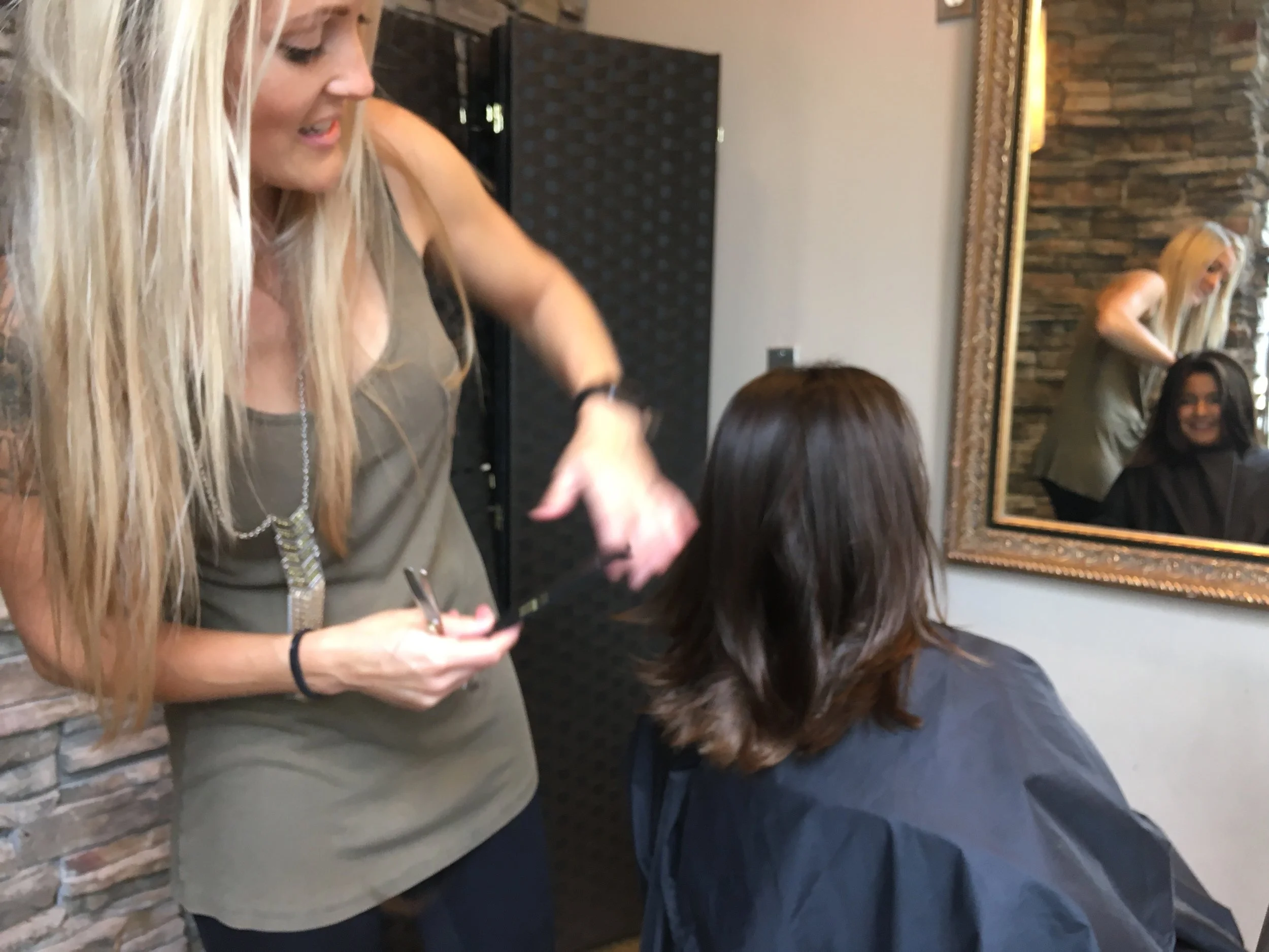 Cybele cutting Bella's hair after an hour of brushing out and deep conditioning. When Cybele wasn't there the time before, it took 4 stylists to comb out Bella's tangles after a summer filled with swimming! Gnarly!